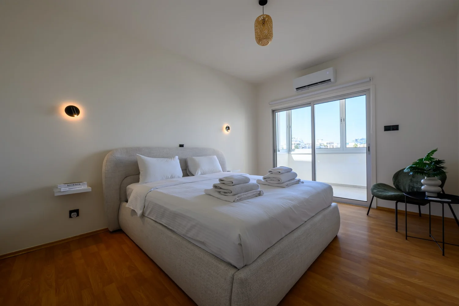Calian Court — Bedroom one — double bed and lounge chair