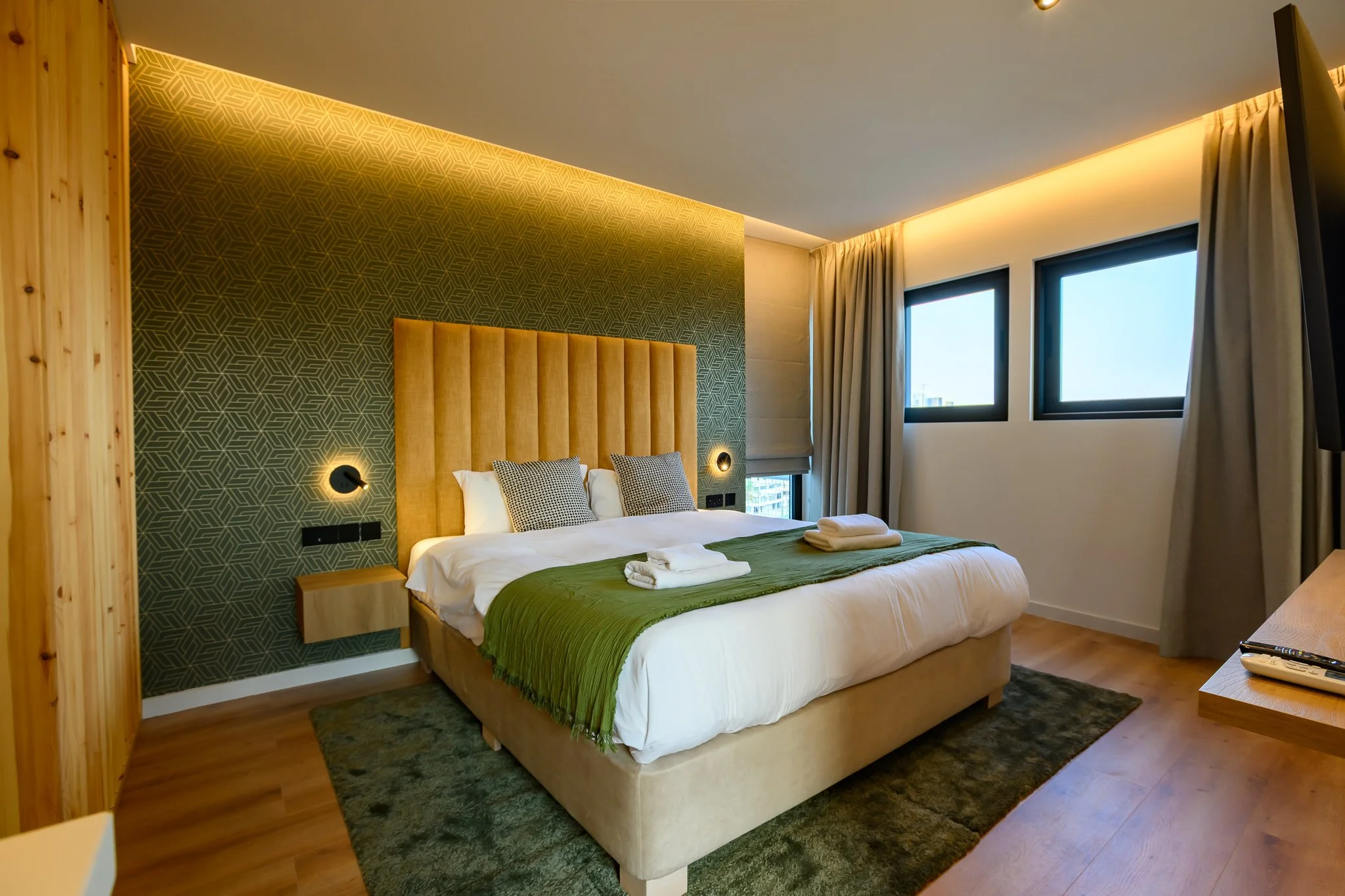 Corner Suite at Nisia Suites with king bed and windows on two sides