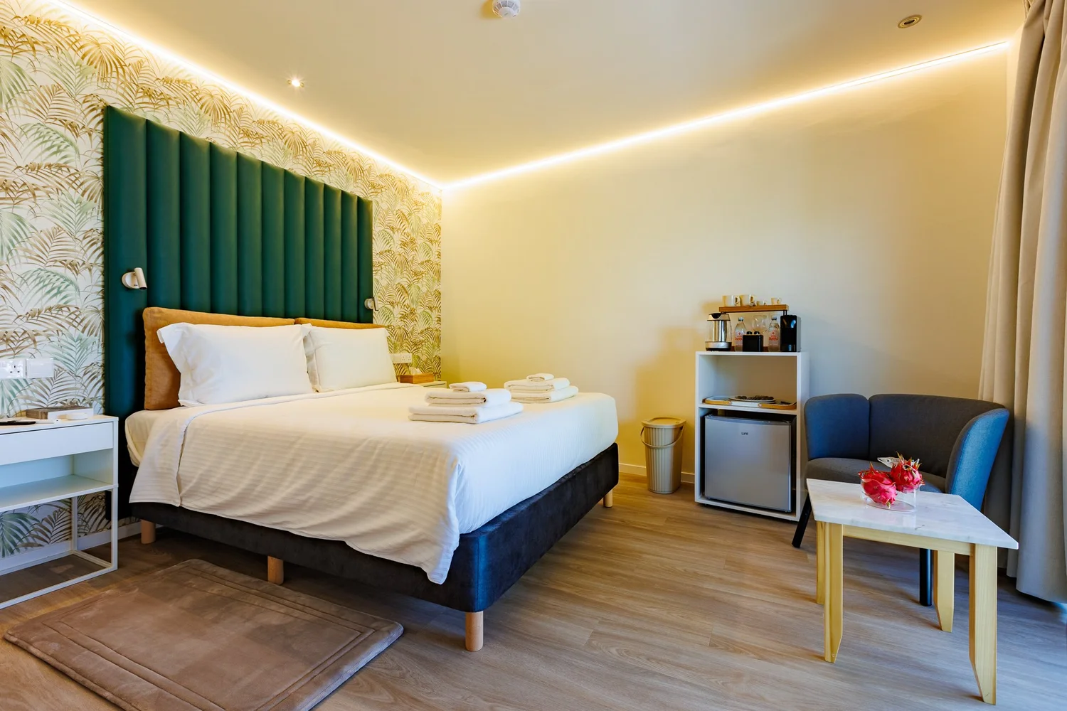 The Palm Suites Suite 2 — Bedroom with armchair and coffee corner