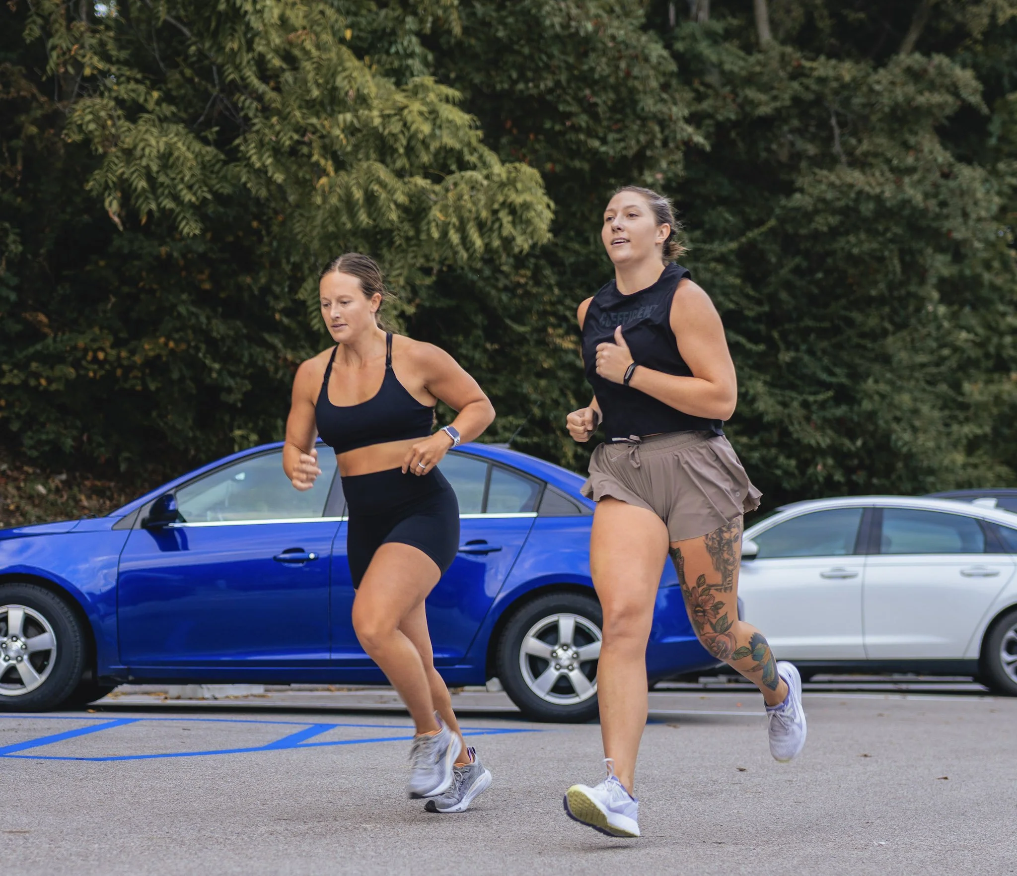 Two members running outside the gym