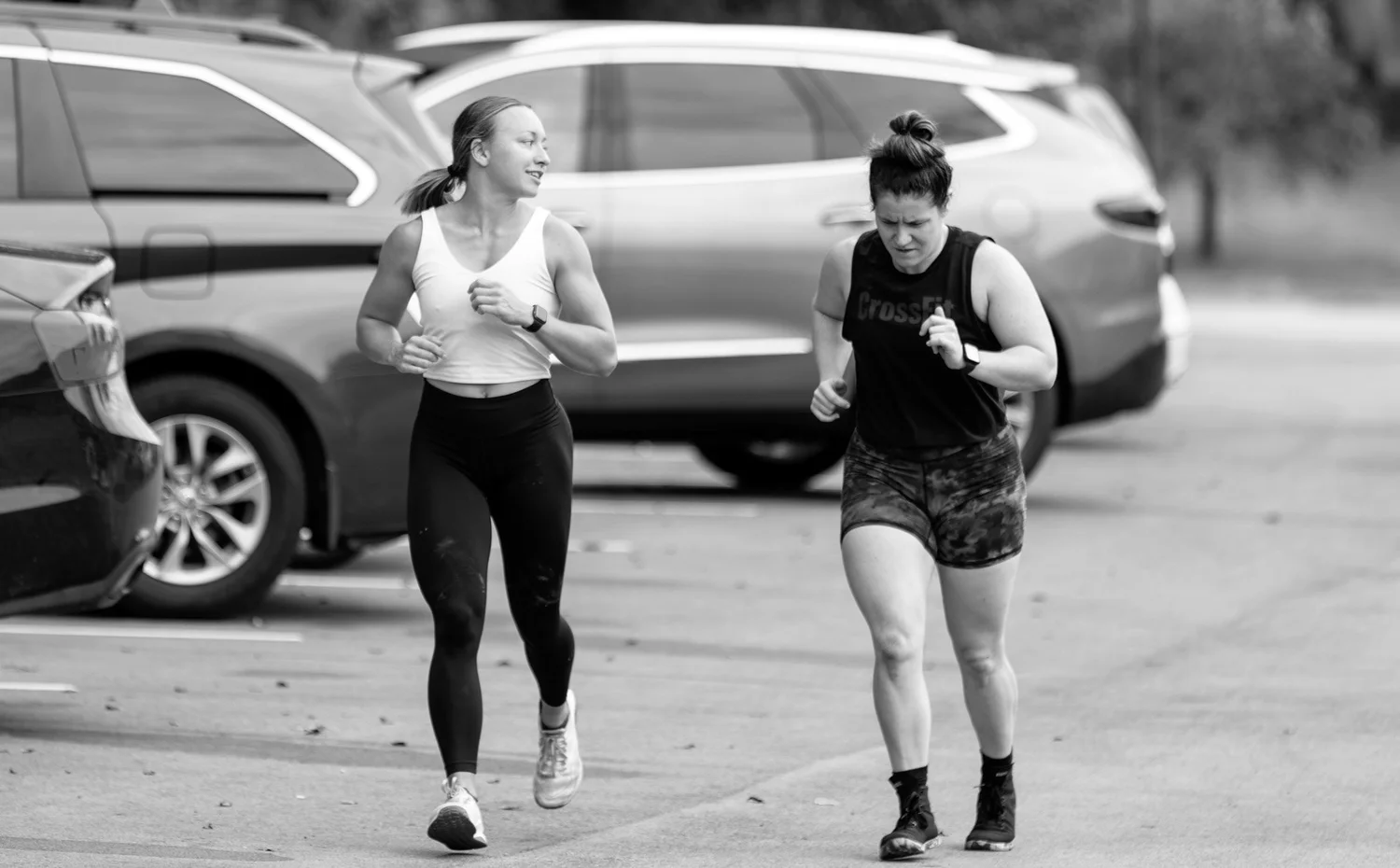 Two members running outside the gym