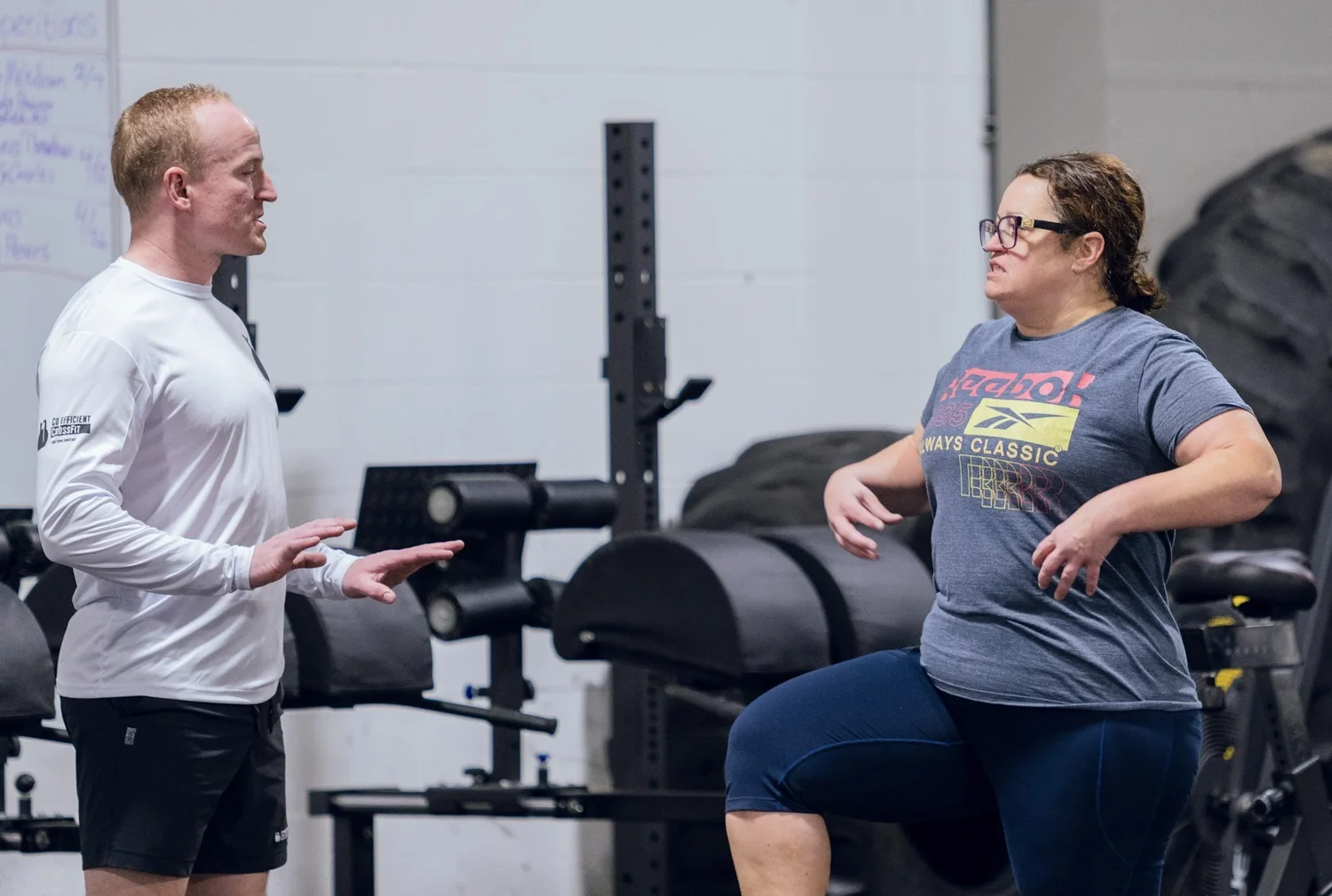 Coach talking a new member through a movement