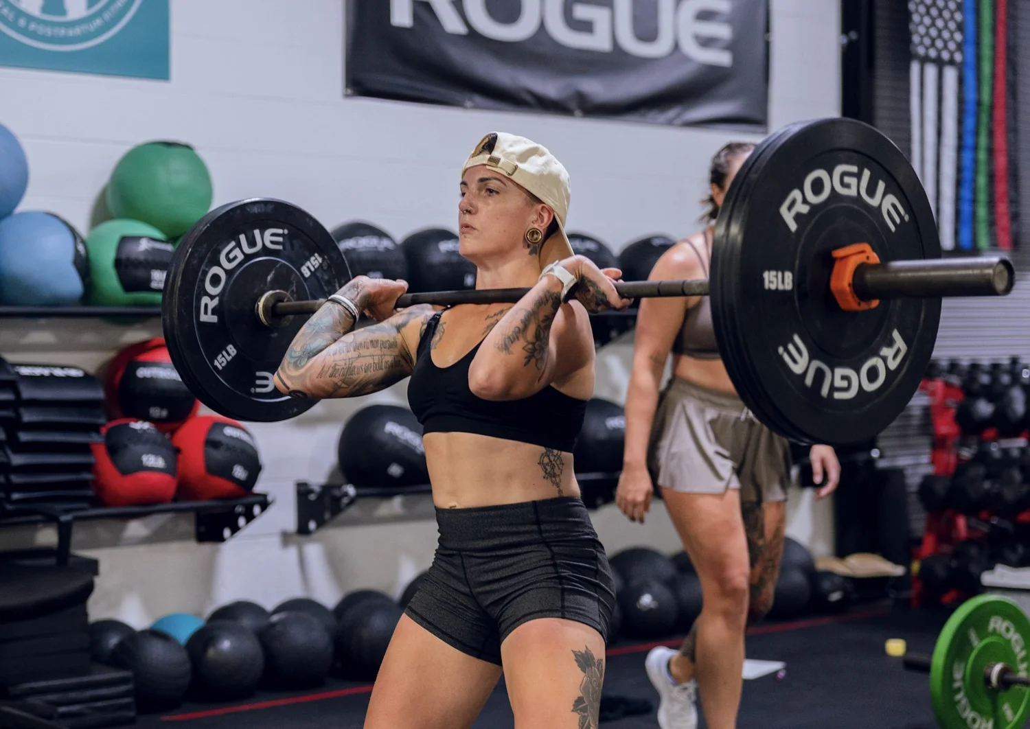 Member front-racking a loaded barbell
