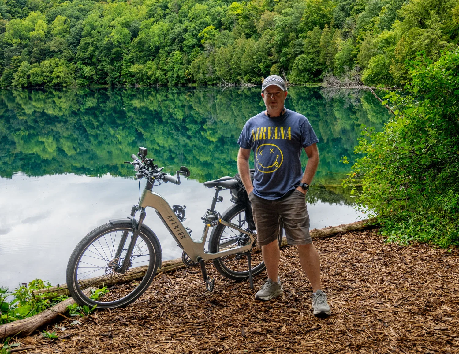 Gregg Ordon, headshot photographer in Syracuse NY, standing beside his bike at a lake in Central New York