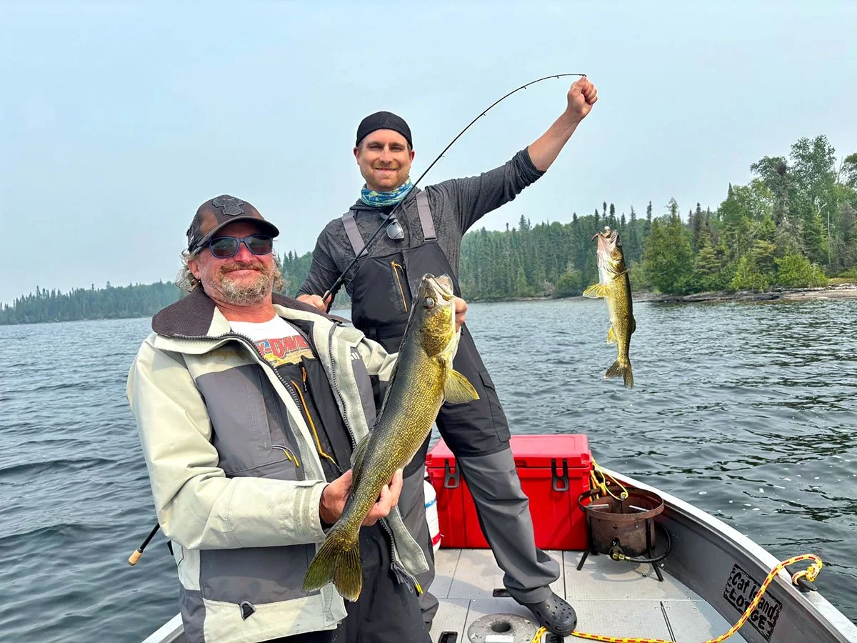 Two anglers holding walleye caught on Trout Lake