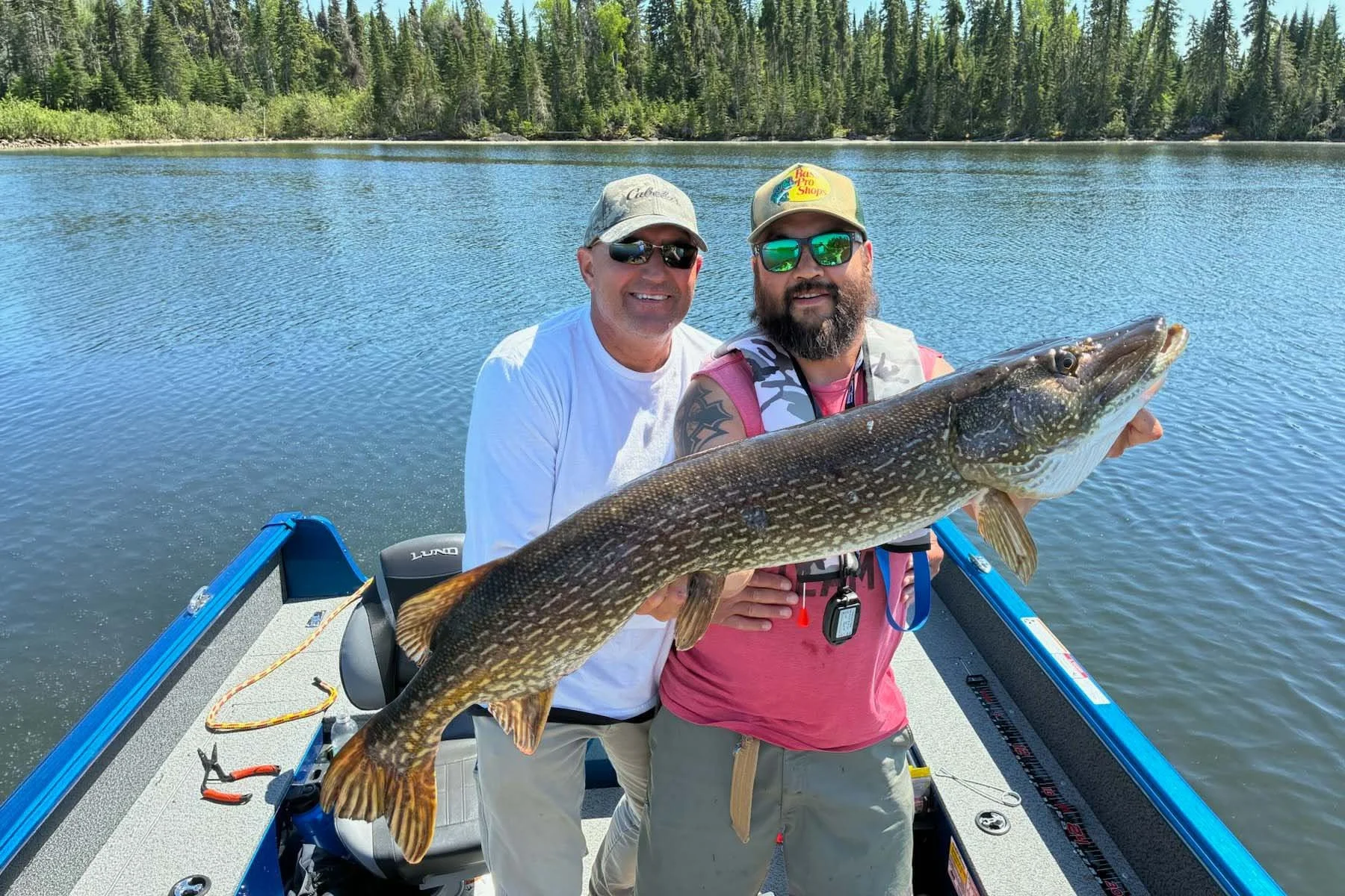 Cat Island Lodge guests holding a trophy northern pike