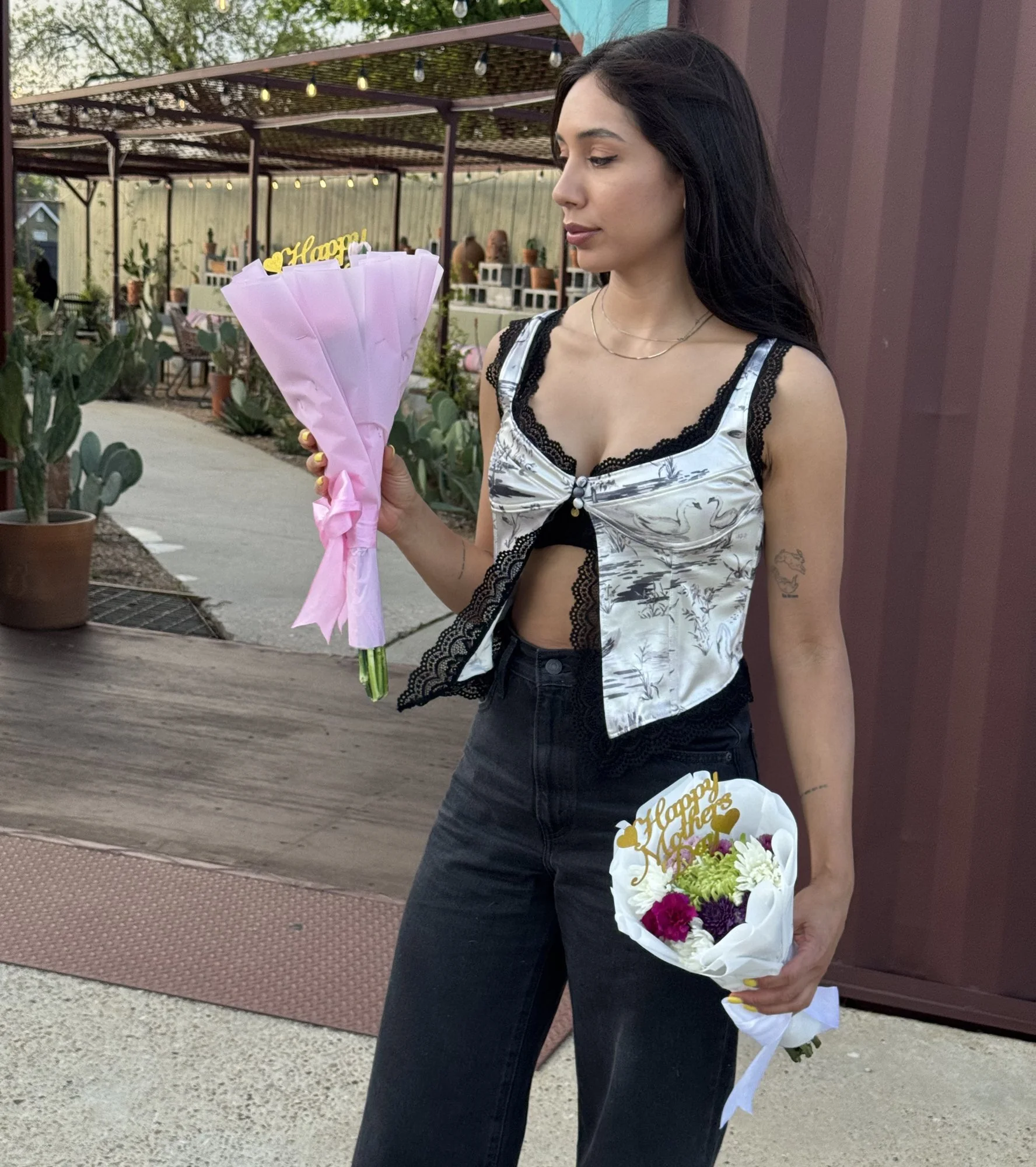 Vanesa Acosta holding a Happy Mother's Day bouquet at Face It Dermalab in Dallas