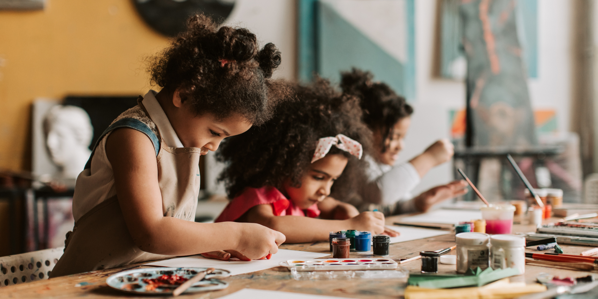 Child painting at a table during a therapy session