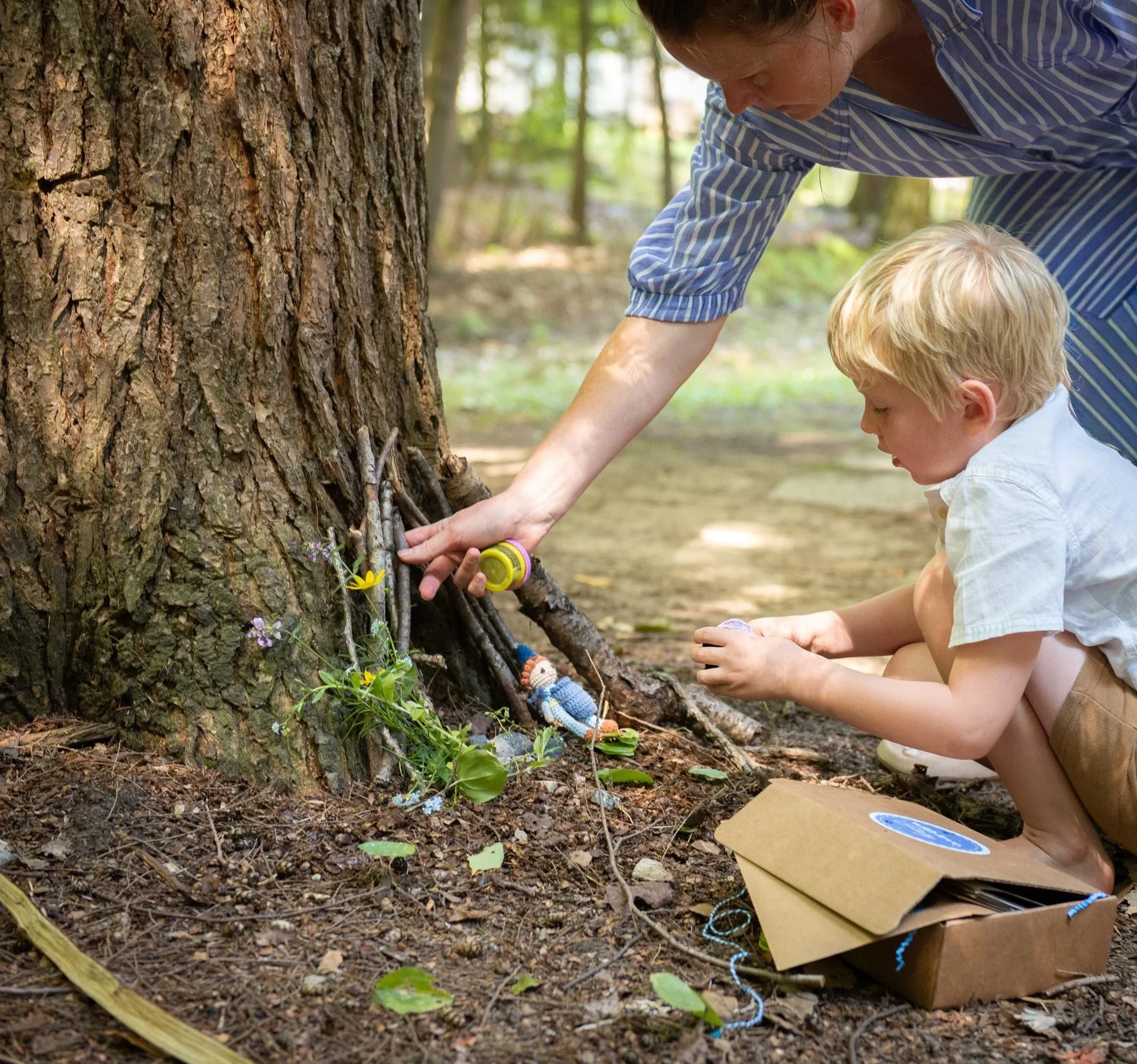 Parent and child building a fairy house together