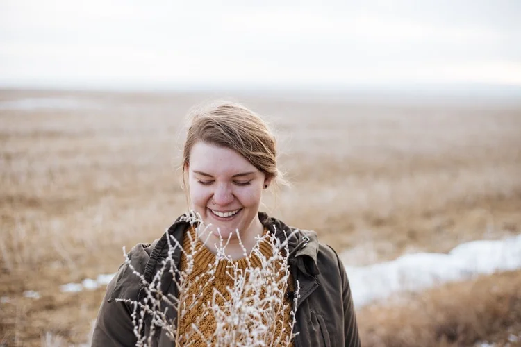 Person standing calmly in a natural outdoor setting