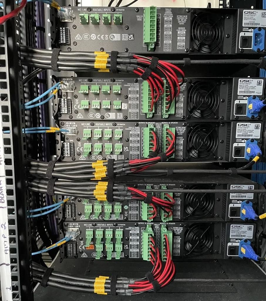 Q-SYS amplifier and DSP rack built and wired by Connective Integrations for a multi-zone commercial audio system