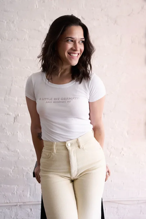 Liz smiling in a white tee