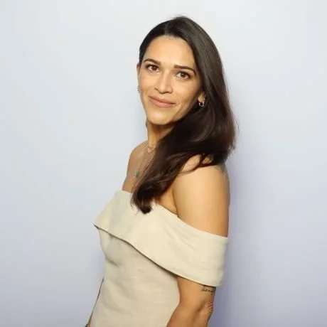 Liz, portrait against a pale wall
