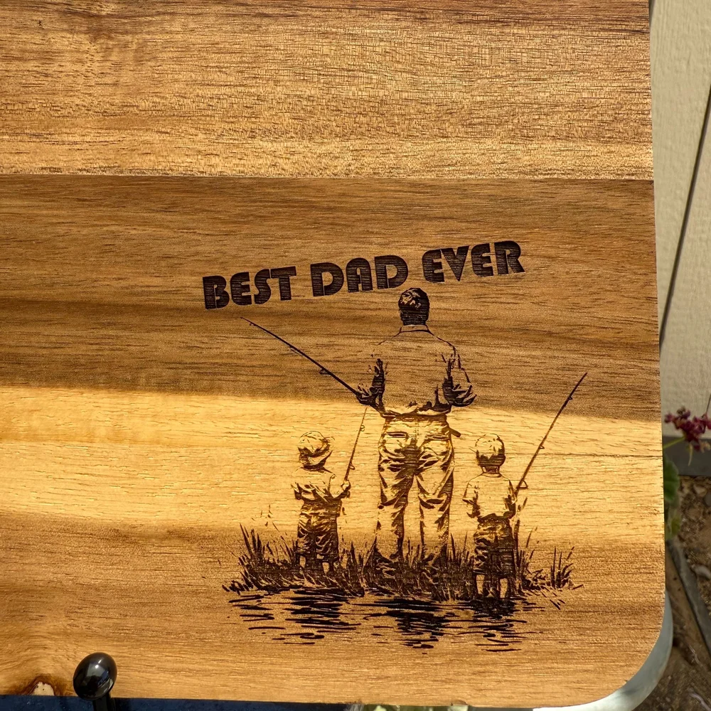 Wood cutting board engraved with a fishing scene