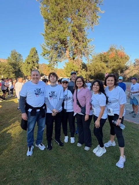 A team of participants in Run for Justice shirts poses in Griffith Park