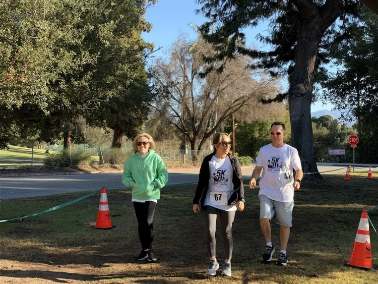 Three participants walk the course together