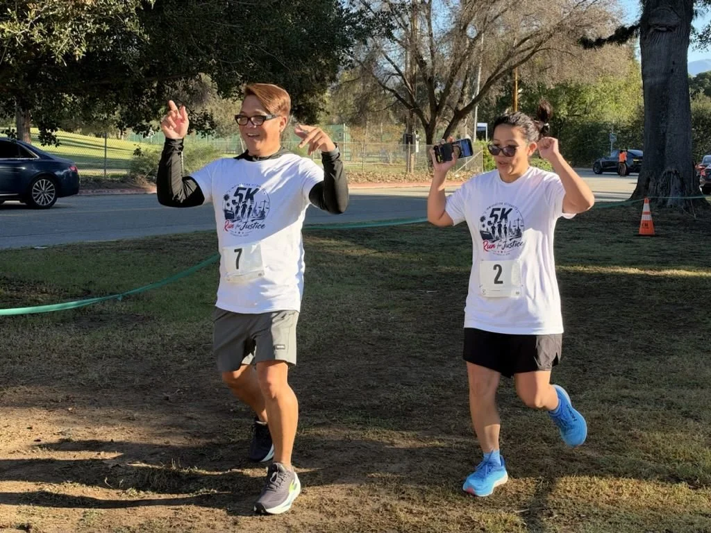 Two runners celebrate as they near the finish