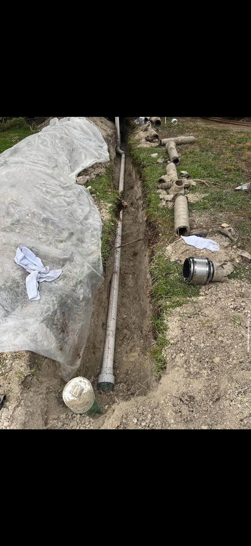 Technician working in a crawlspace on drain lines