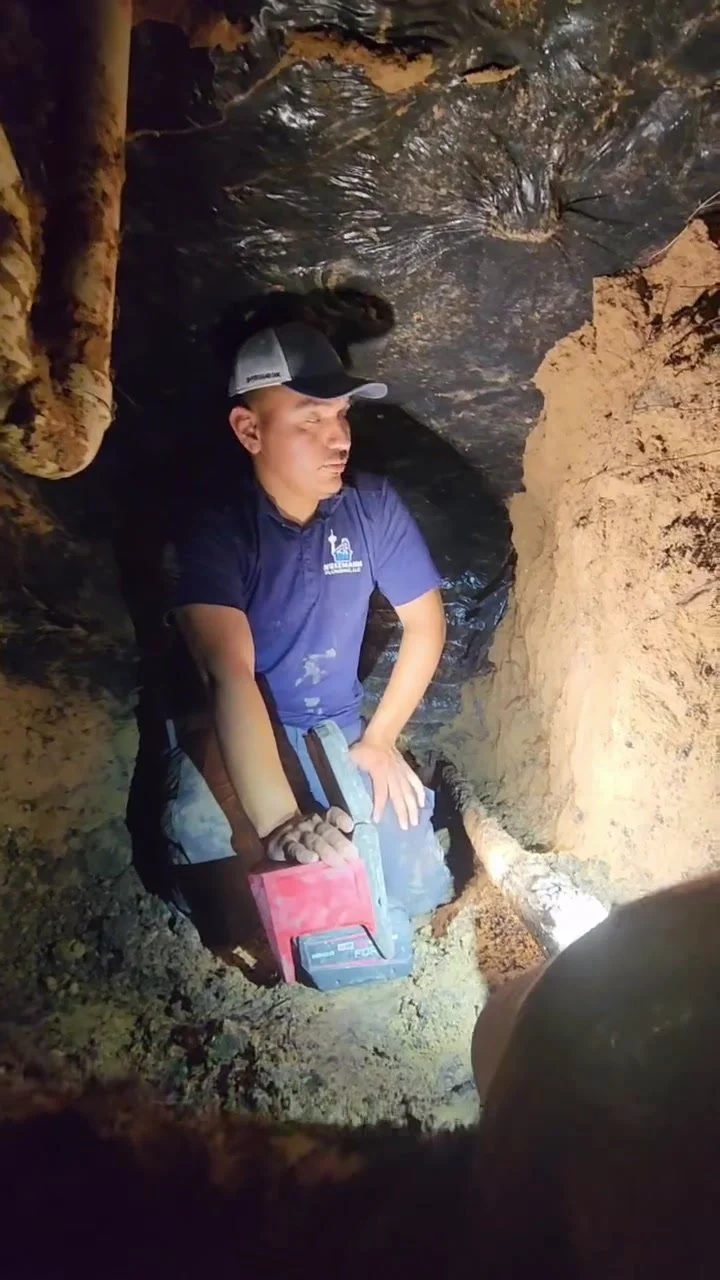 Technician tunneling under a slab foundation