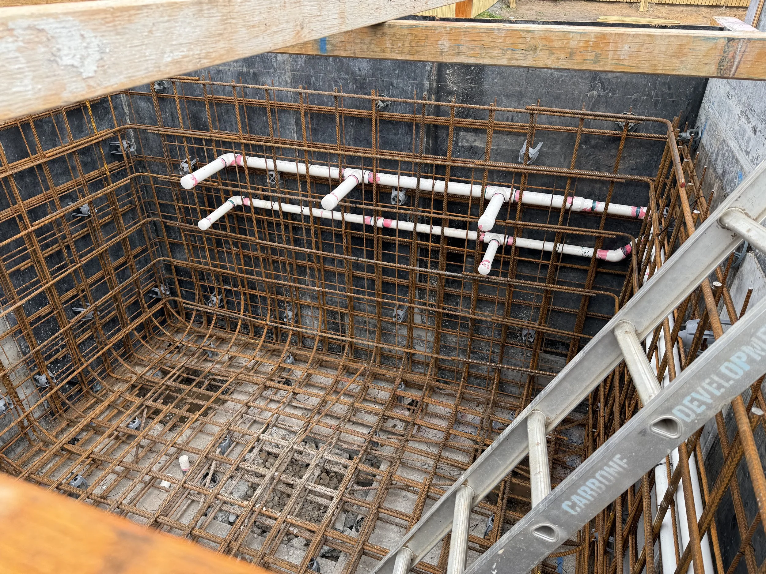 Pool plumbing lines being set out at the start of the job