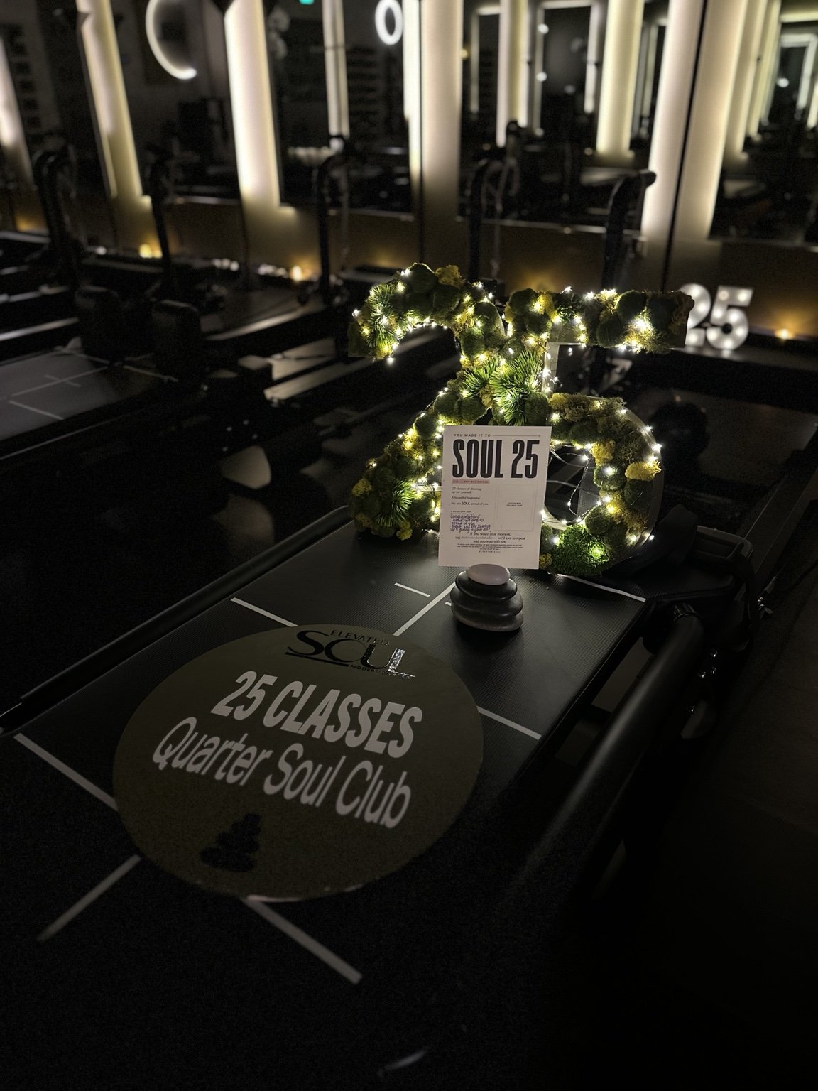 An illuminated 25-class milestone celebration with a handwritten note