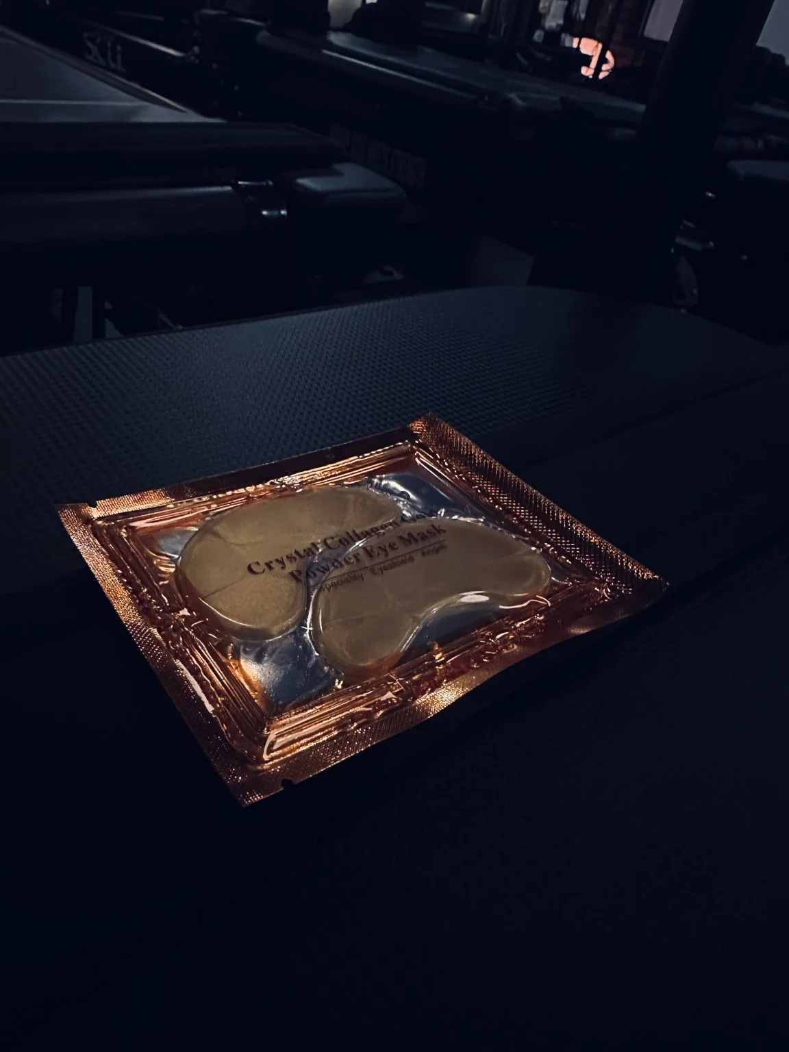 Gold under-eye patches waiting on a studio reformer