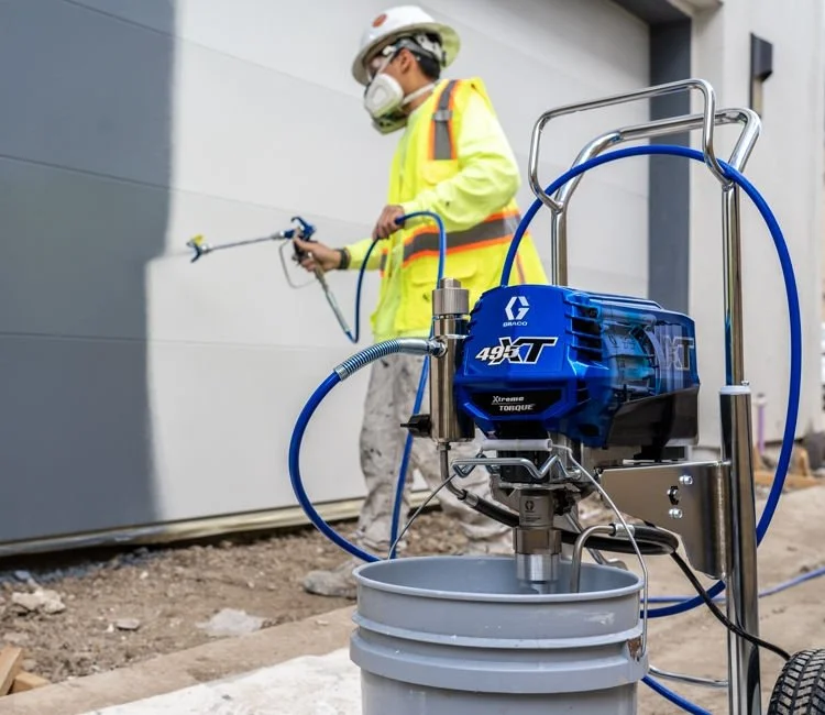 Professional using a Graco airless sprayer