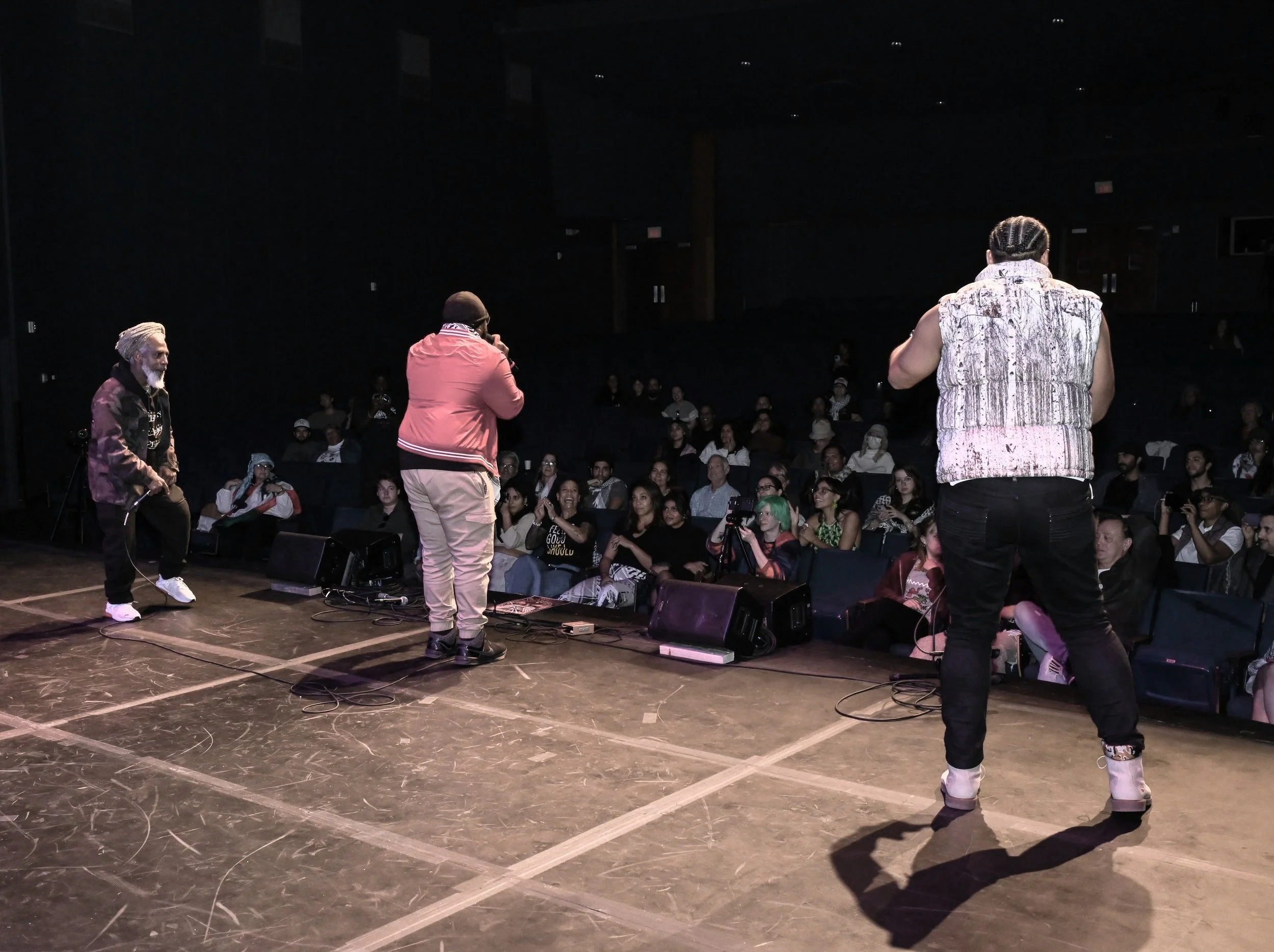 Chizabam onstage facing a seated audience during a live event