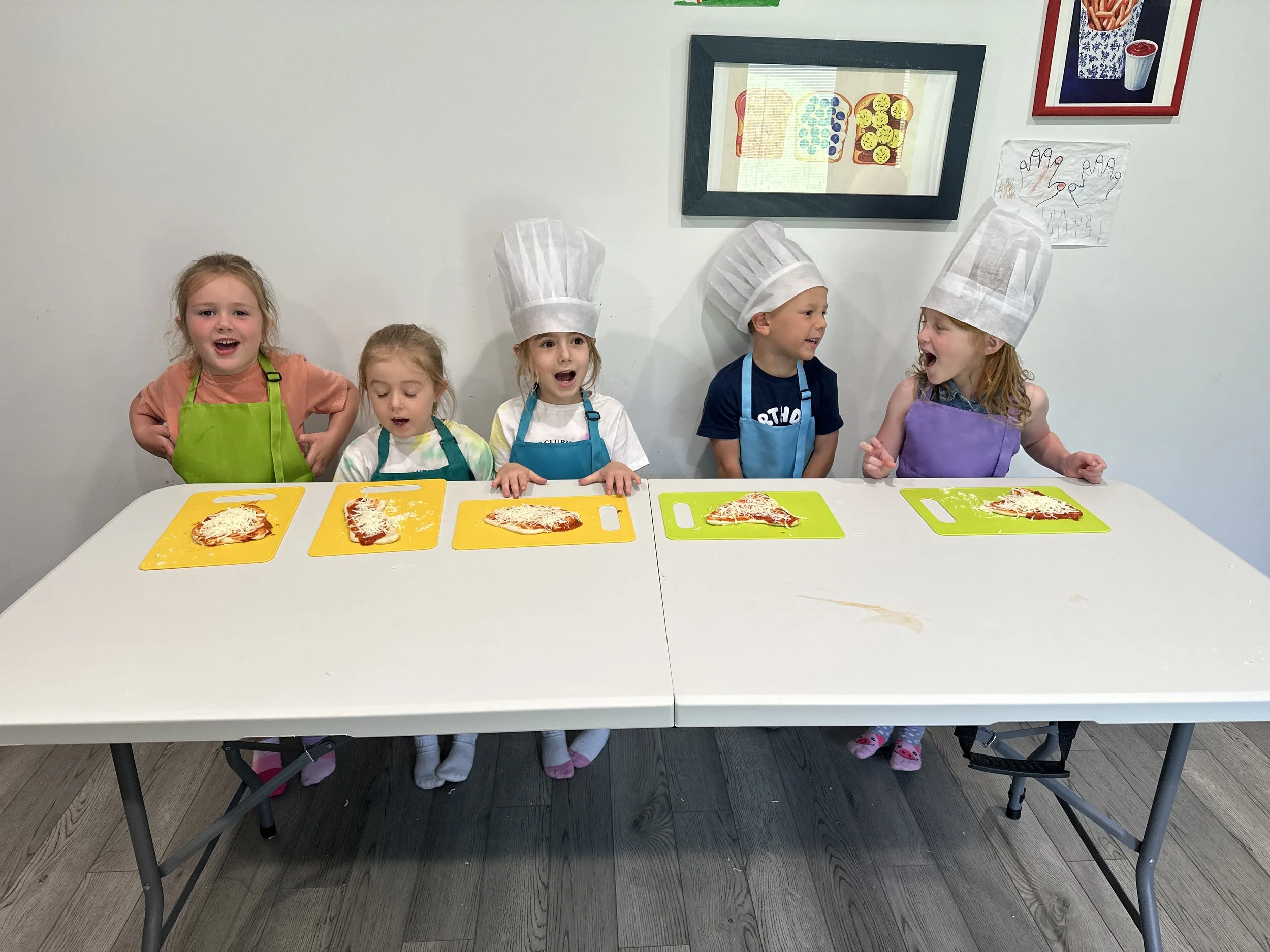 Children making their own
  pizzas during a cooking class at The Clubhouse Phoenixville