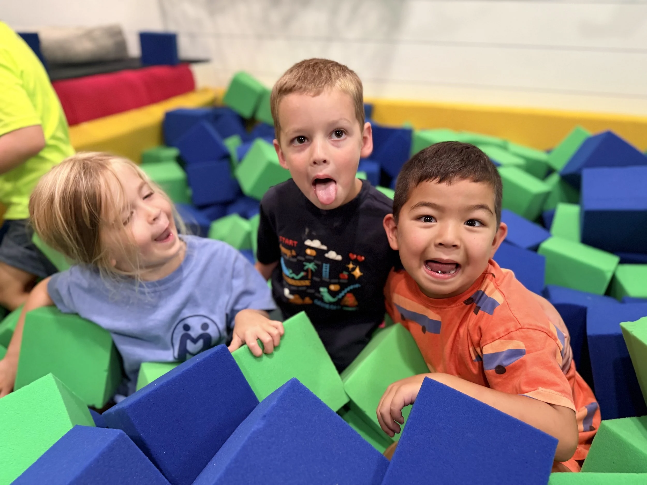 Preschoolers playing together in the
      foam block pit at The Clubhouse Phoenixville