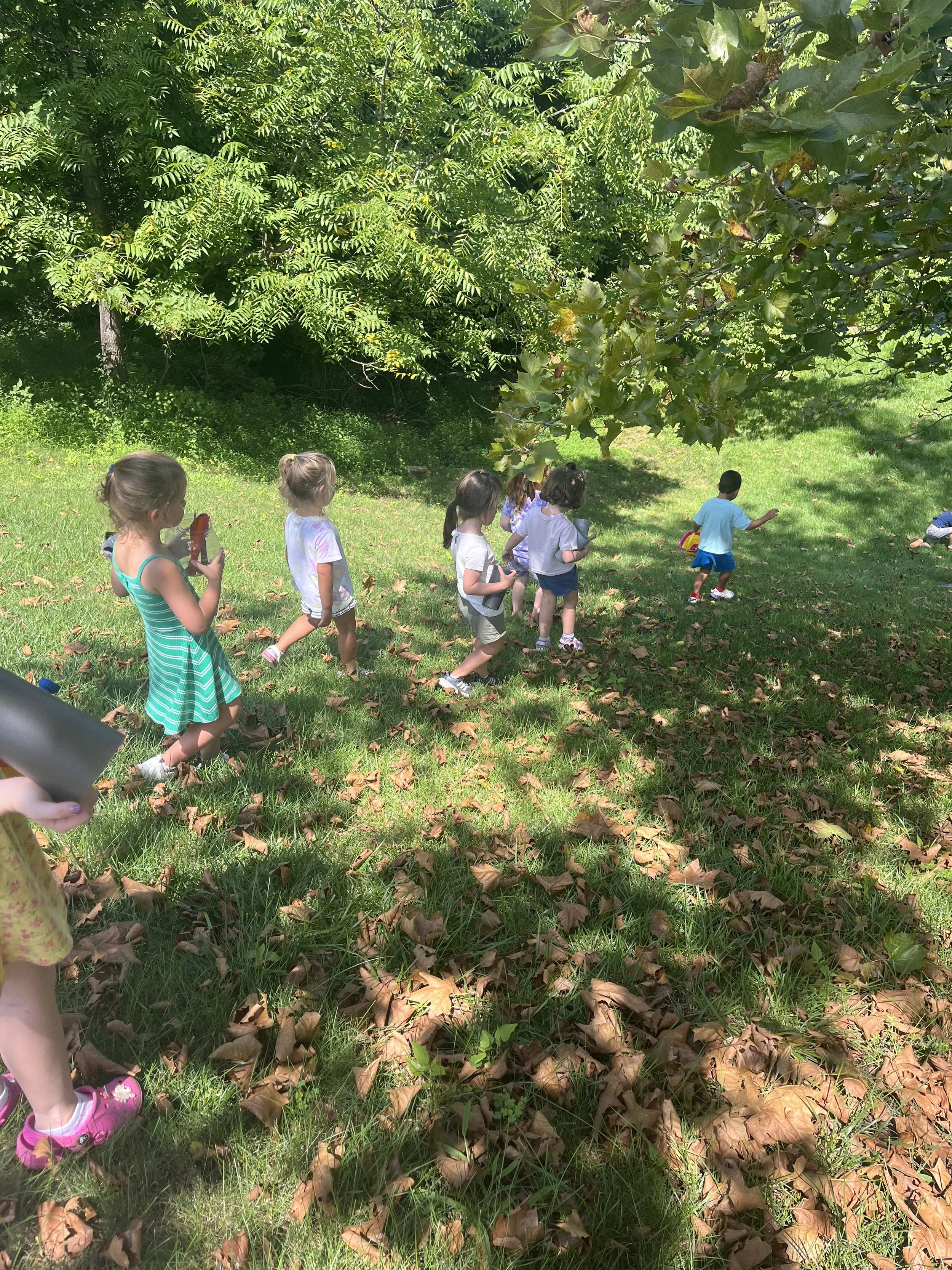 Children on an outdoor
  nature walk during summer camp at The Clubhouse Phoenixville