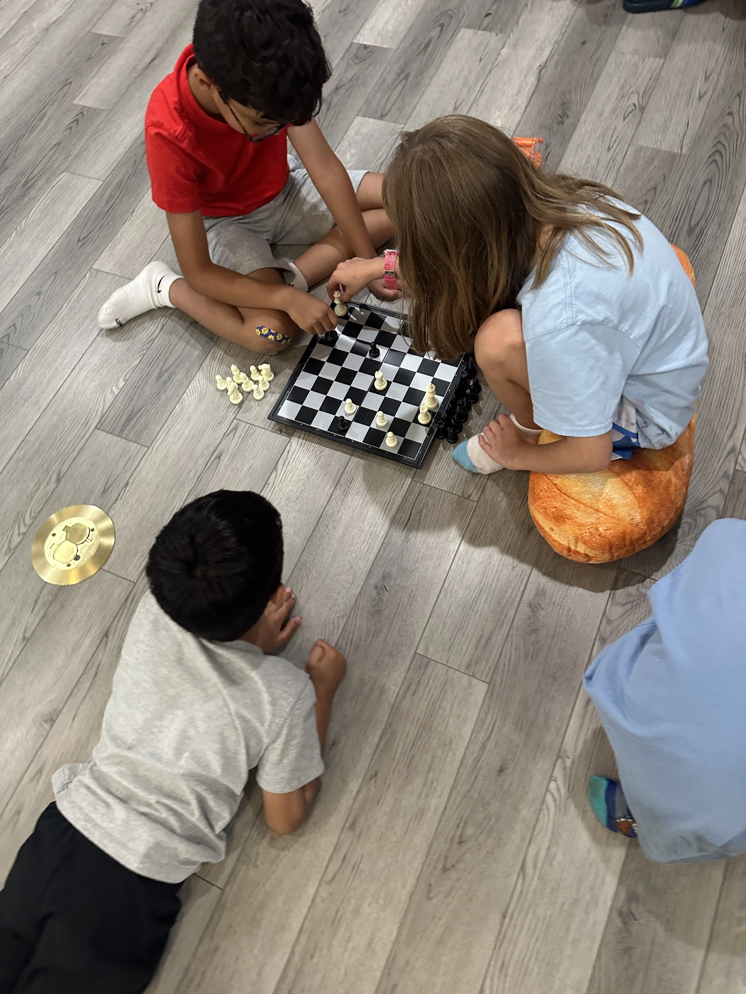 Two children playing chess together at The Clubhouse
      Phoenixville, a screen-free kids enrichment space in Chester County, Pennsylvania