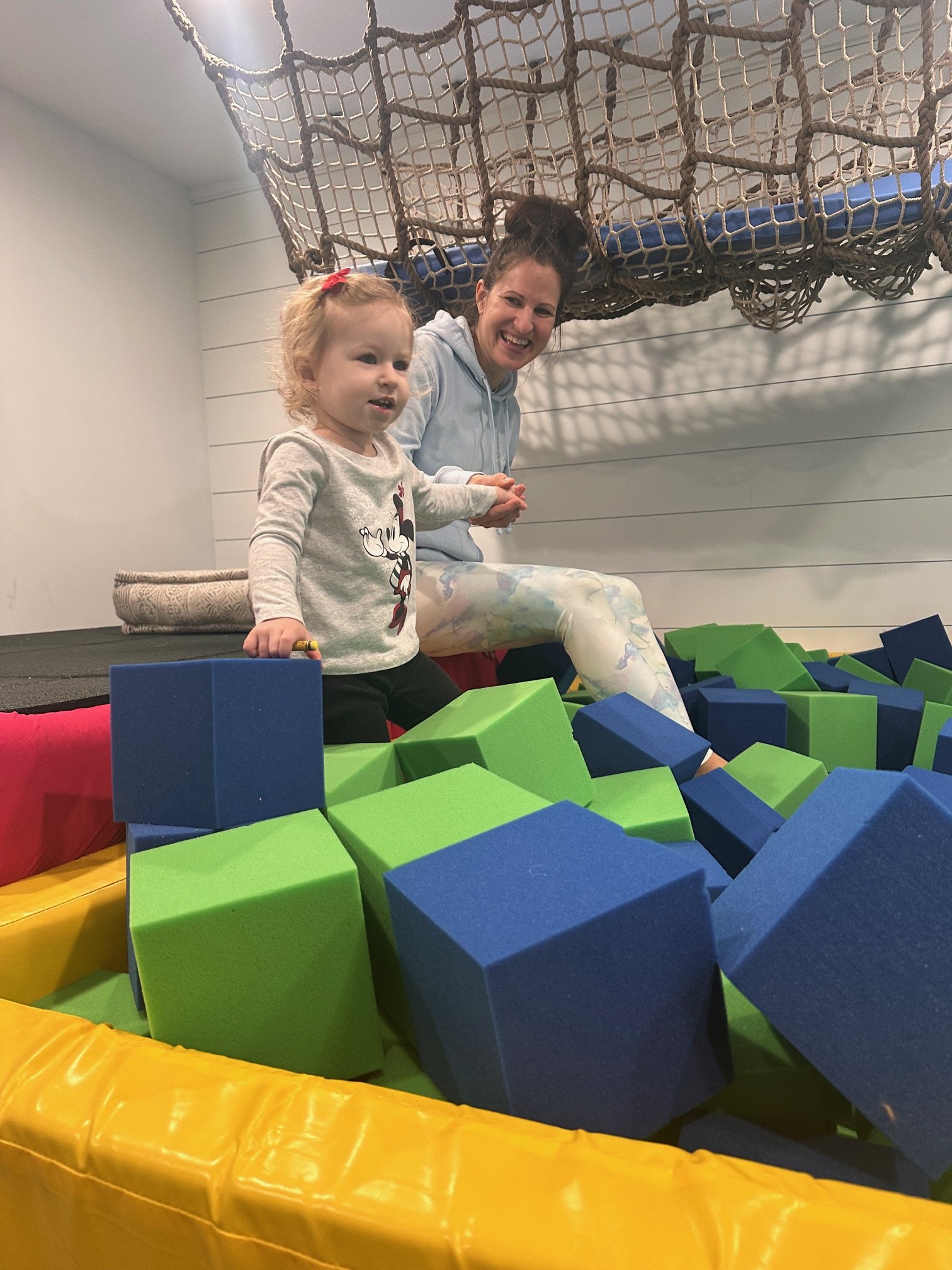 Mom and toddler playing together in foam pit at The Clubhouse Phoenixville PA