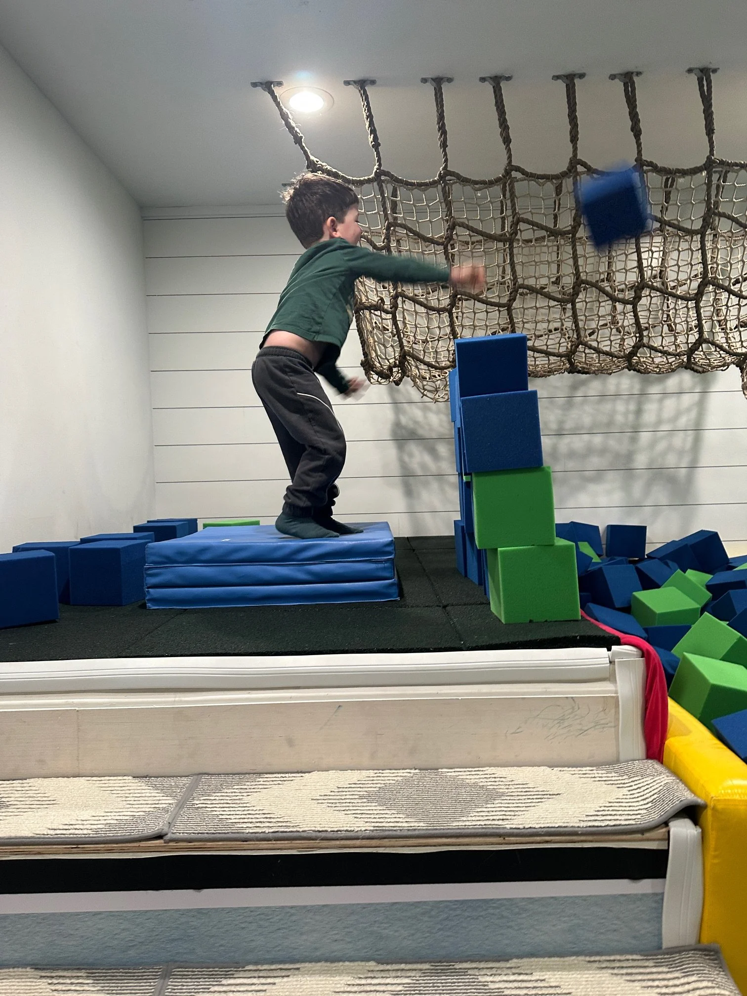 Boy playing with foam pit blocks at indoor play space in Phoenixville PA
