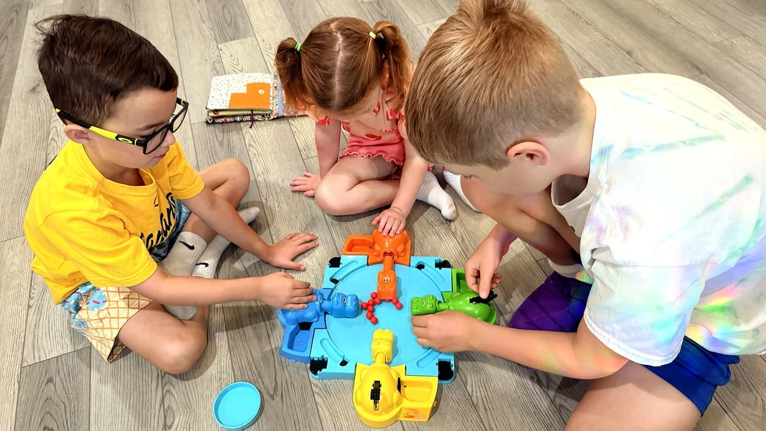 Kids taking turns in a group game at The Clubhouse