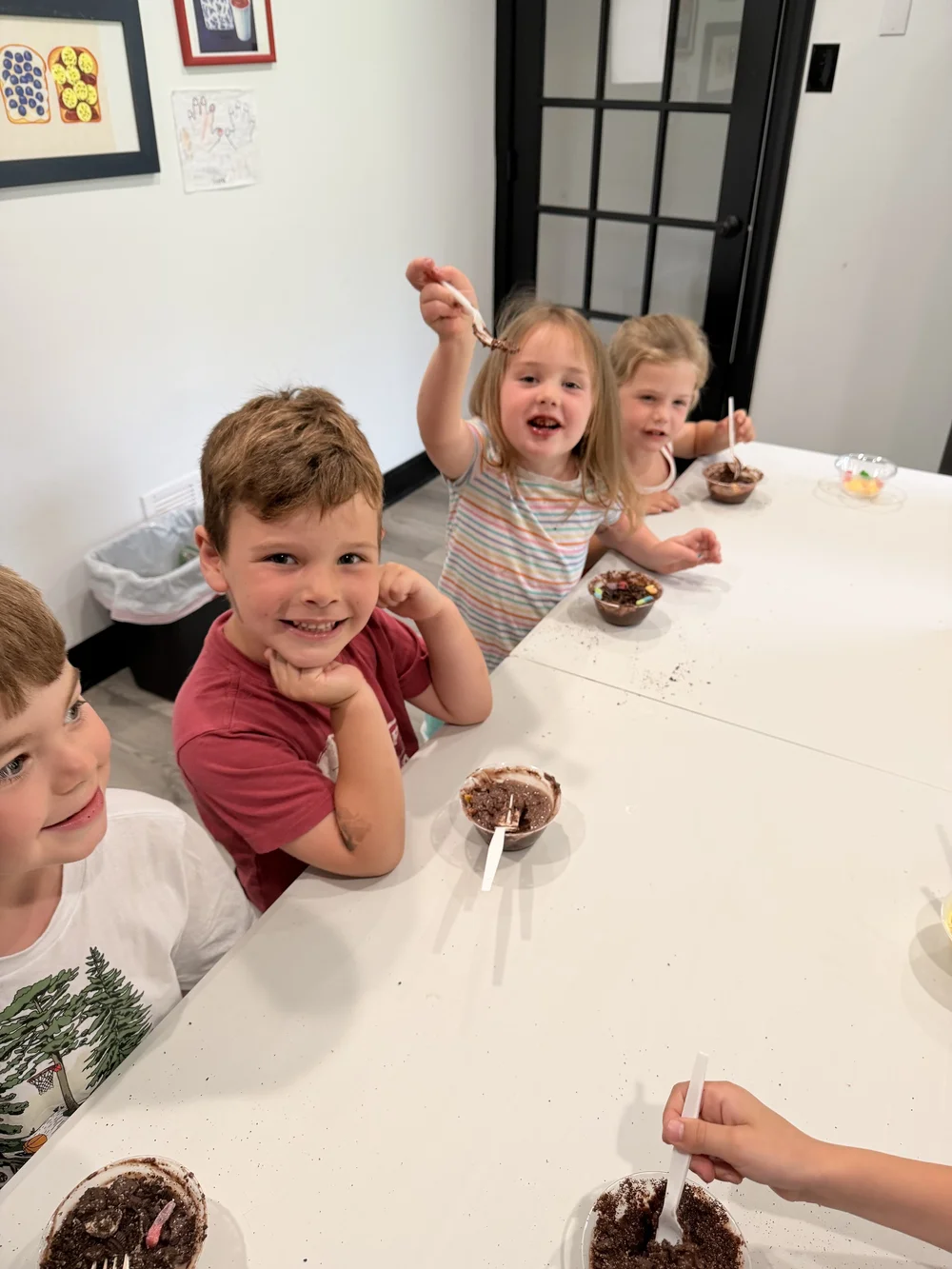 Kids making dirt-cup snacks together at The Clubhouse