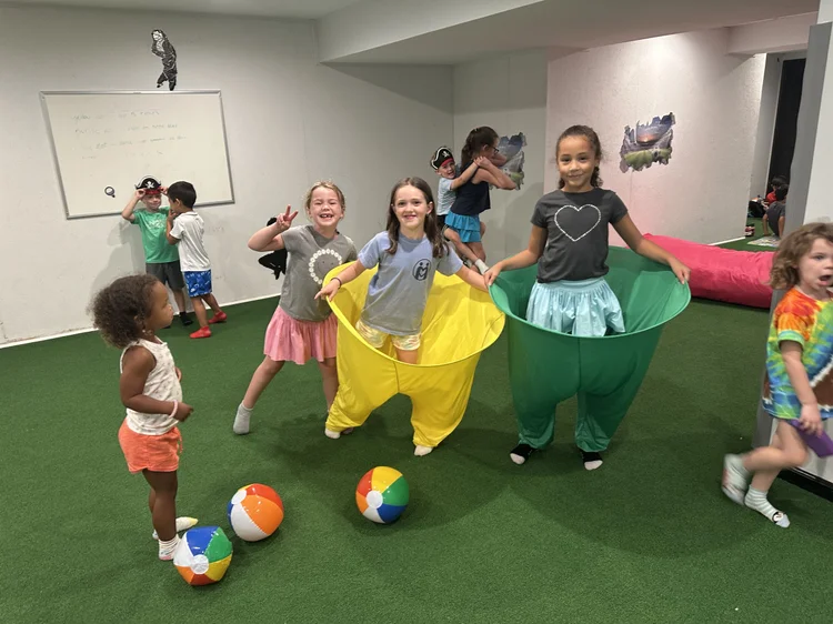 Kids in costumes playing a group game at The Clubhouse