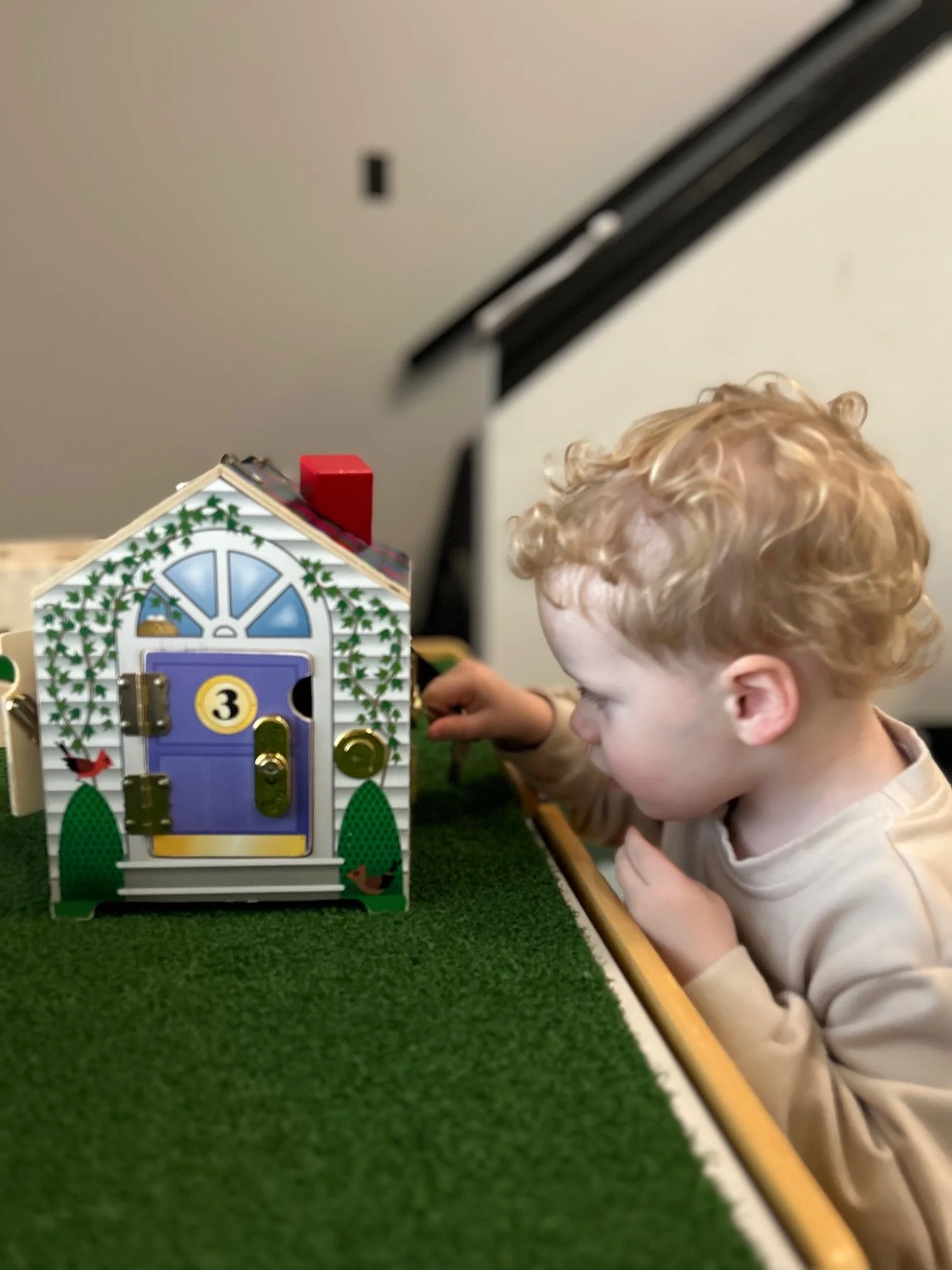 Toddler practicing fine motor skills with sensory toys at The Clubhouse Phoenixville