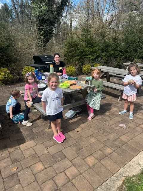 Kids having outdoor picnic snack time at summer camp near Chester County PA
