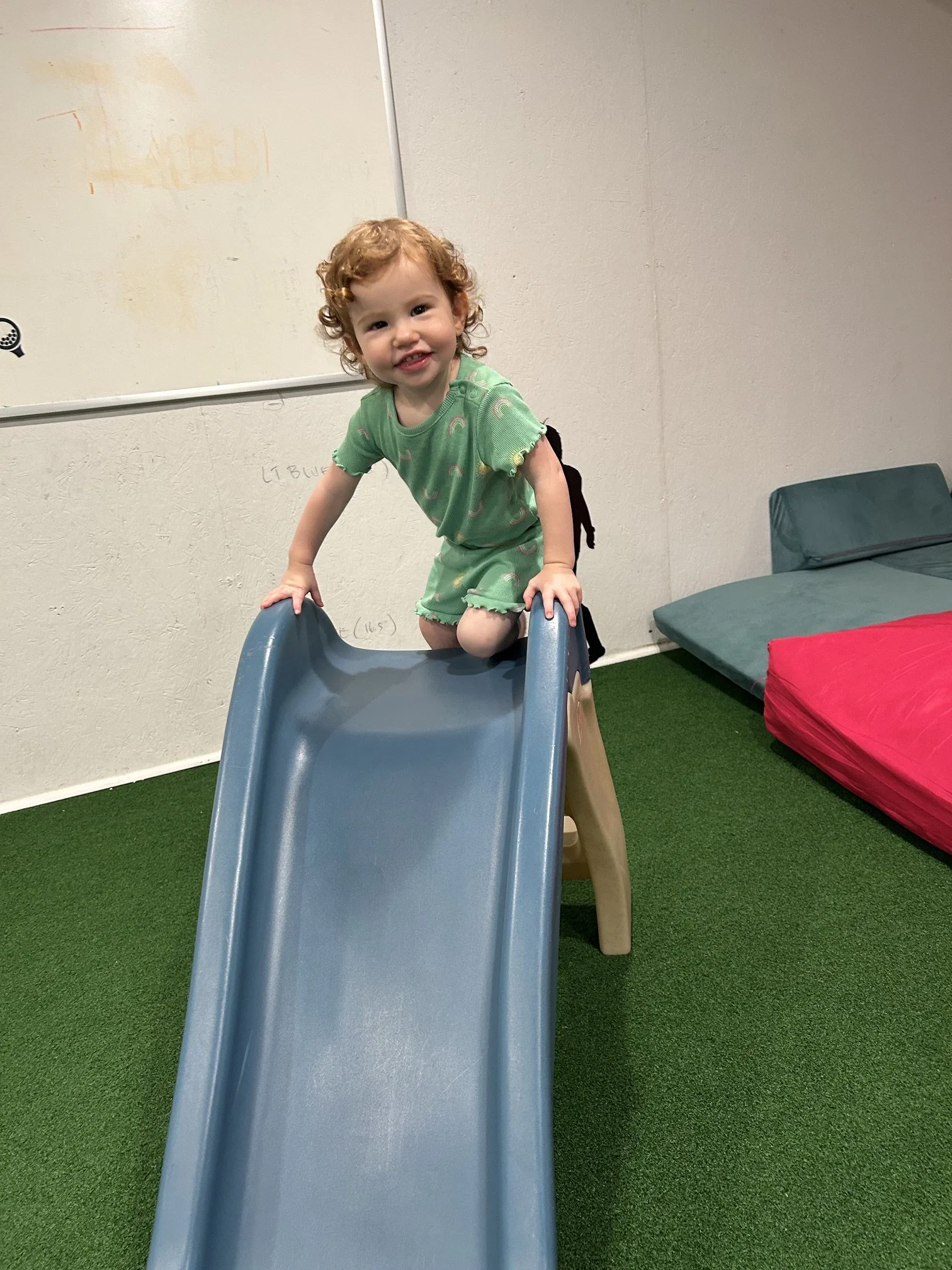 Toddler going down the indoor slide at The Clubhouse — indoor play for little kids in Phoenixville PA