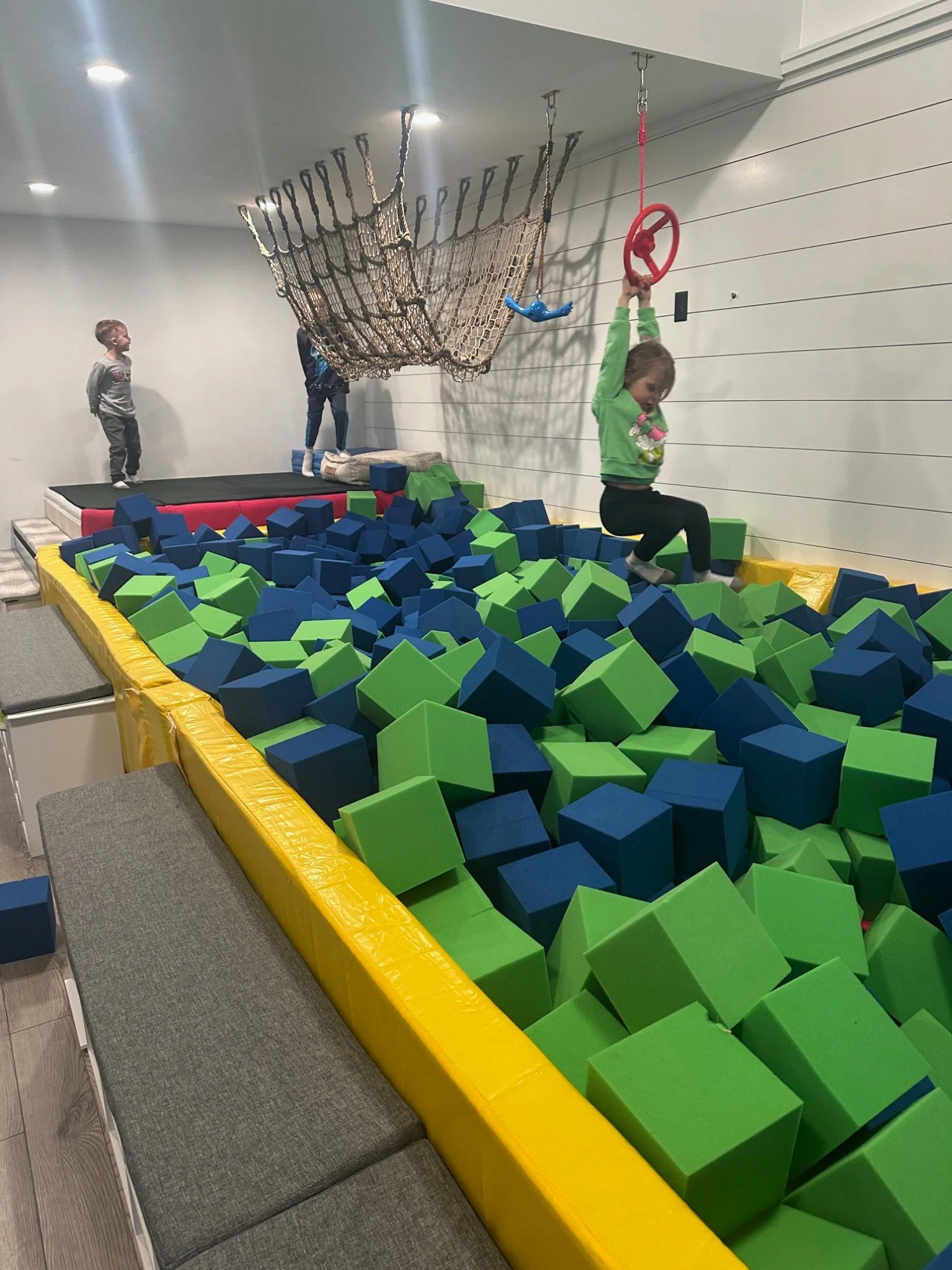 Foam pit with rope swing and gym rings at indoor playground in Phoenixville