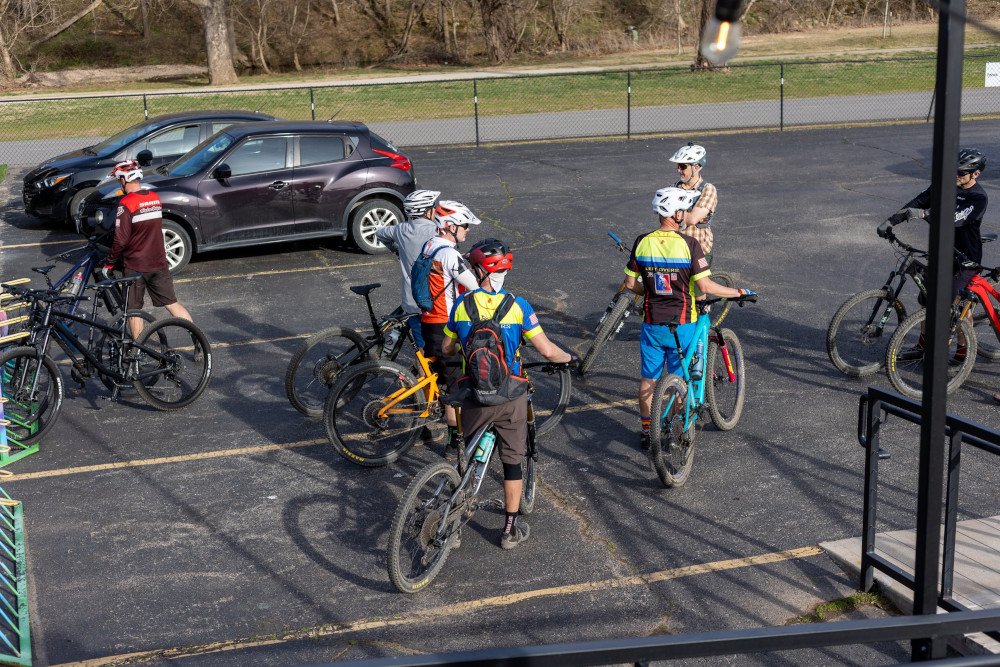 group of cyclists in a closed parking lot