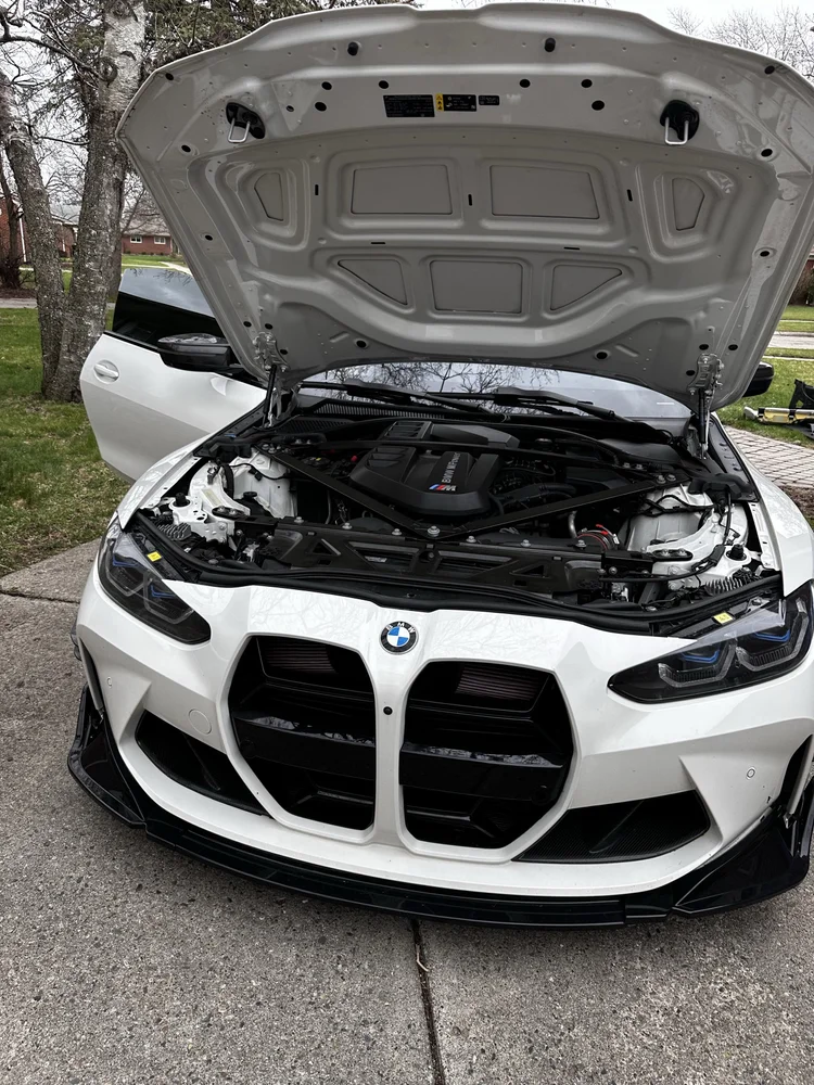 White BMW M4 with the hood open