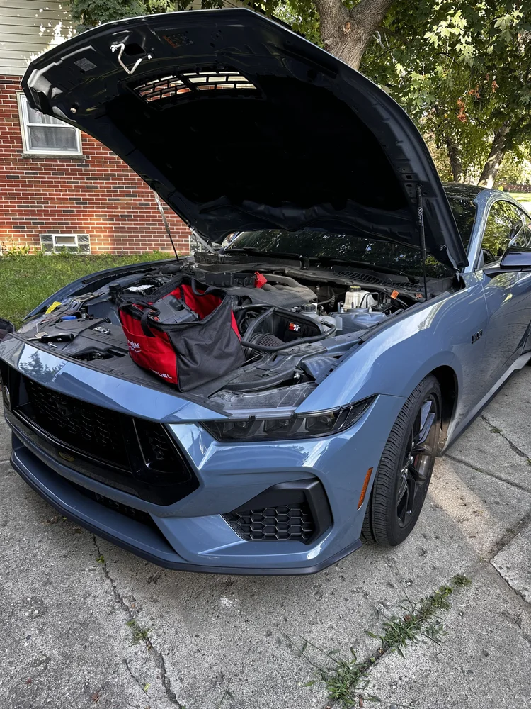 Blue Ford Mustang GT with the hood open