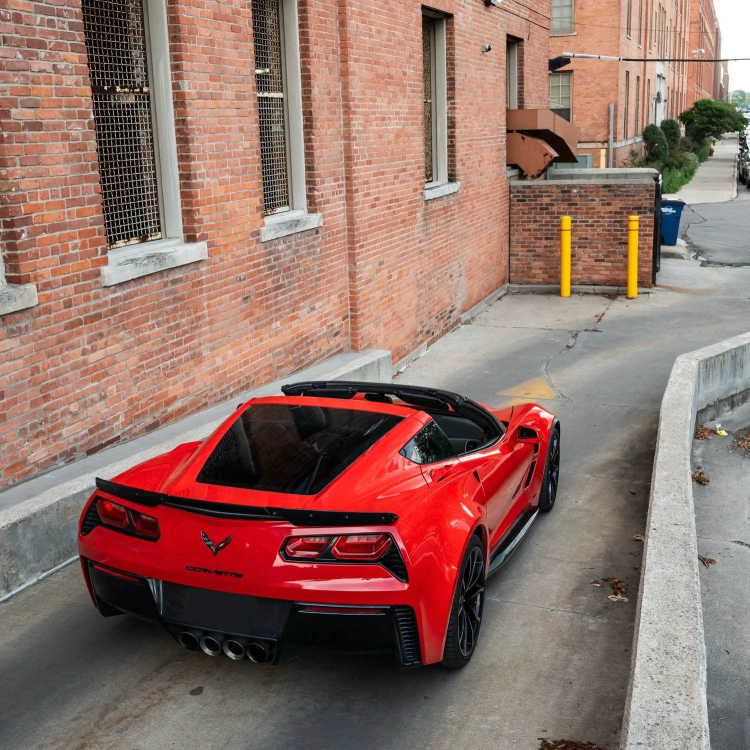 Torch Red C7 Corvette Grand Sport rear three-quarter view — Corsa Nero