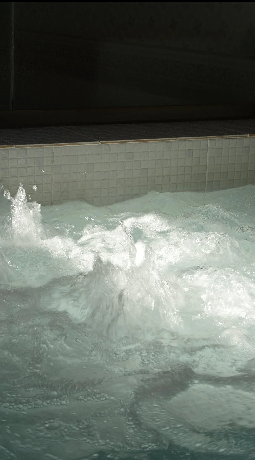 Close-up of warm, foaming water during the black soap step