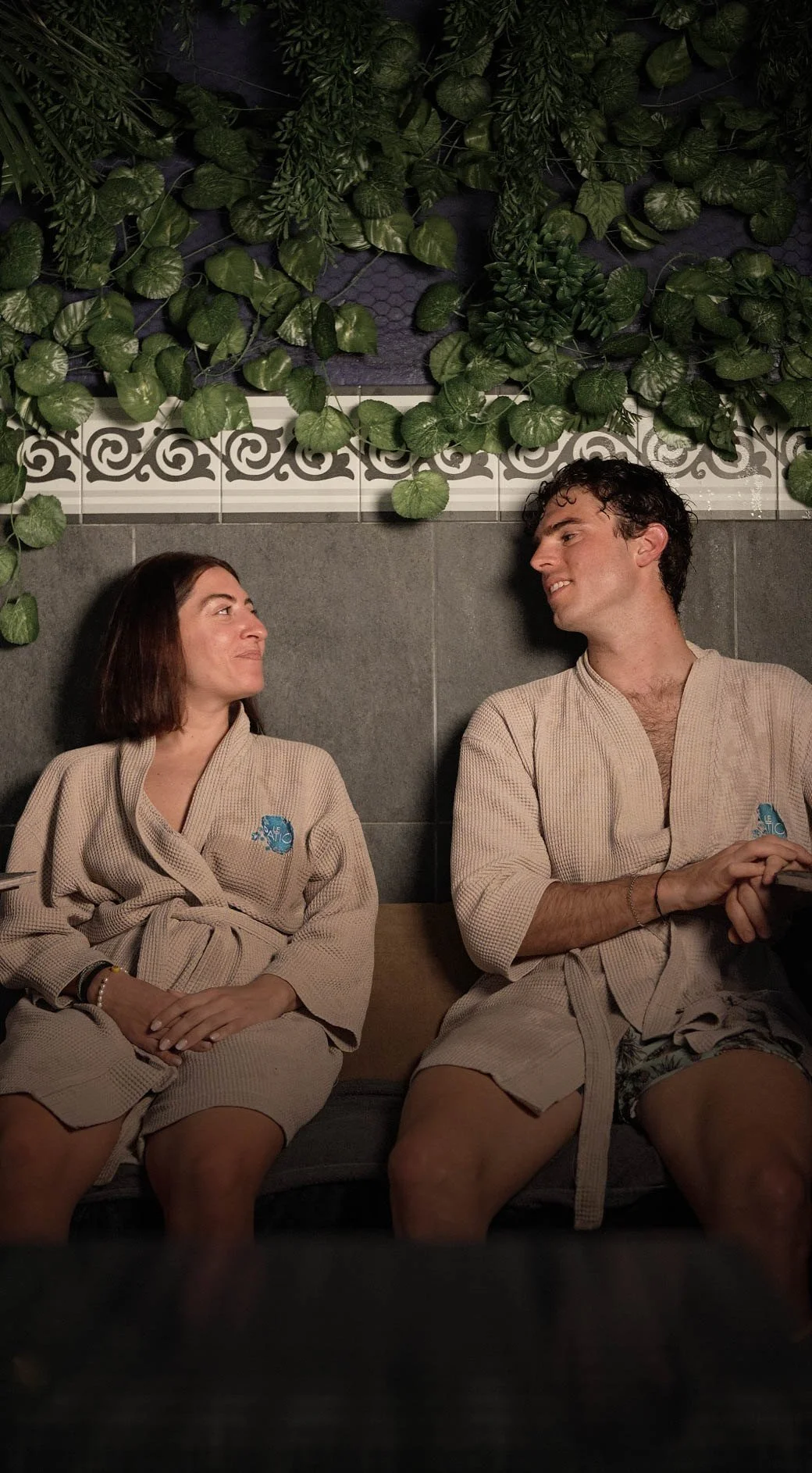 Two guests in robes resting after the circuit