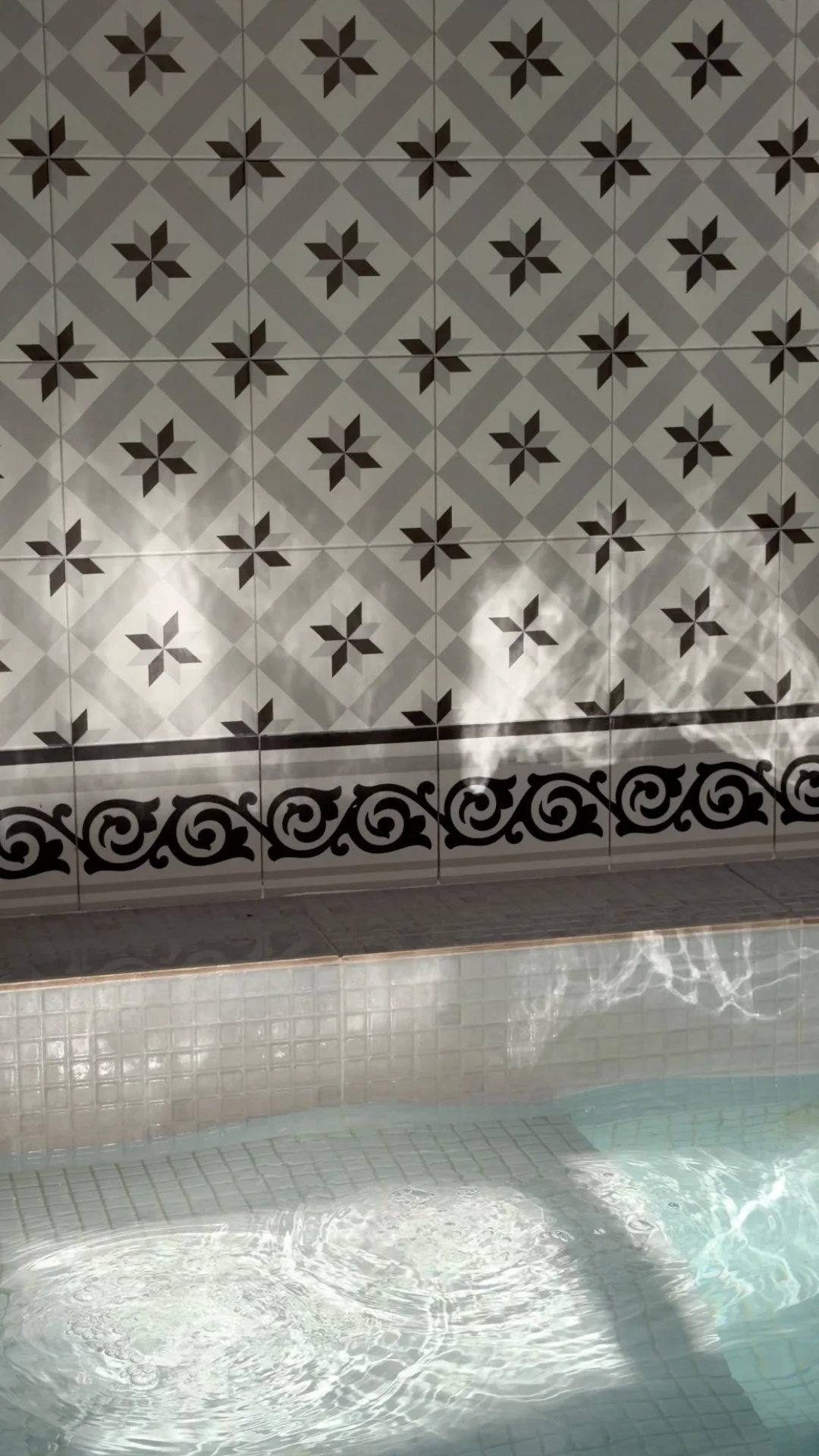 The jacuzzi beneath the patterned tiles