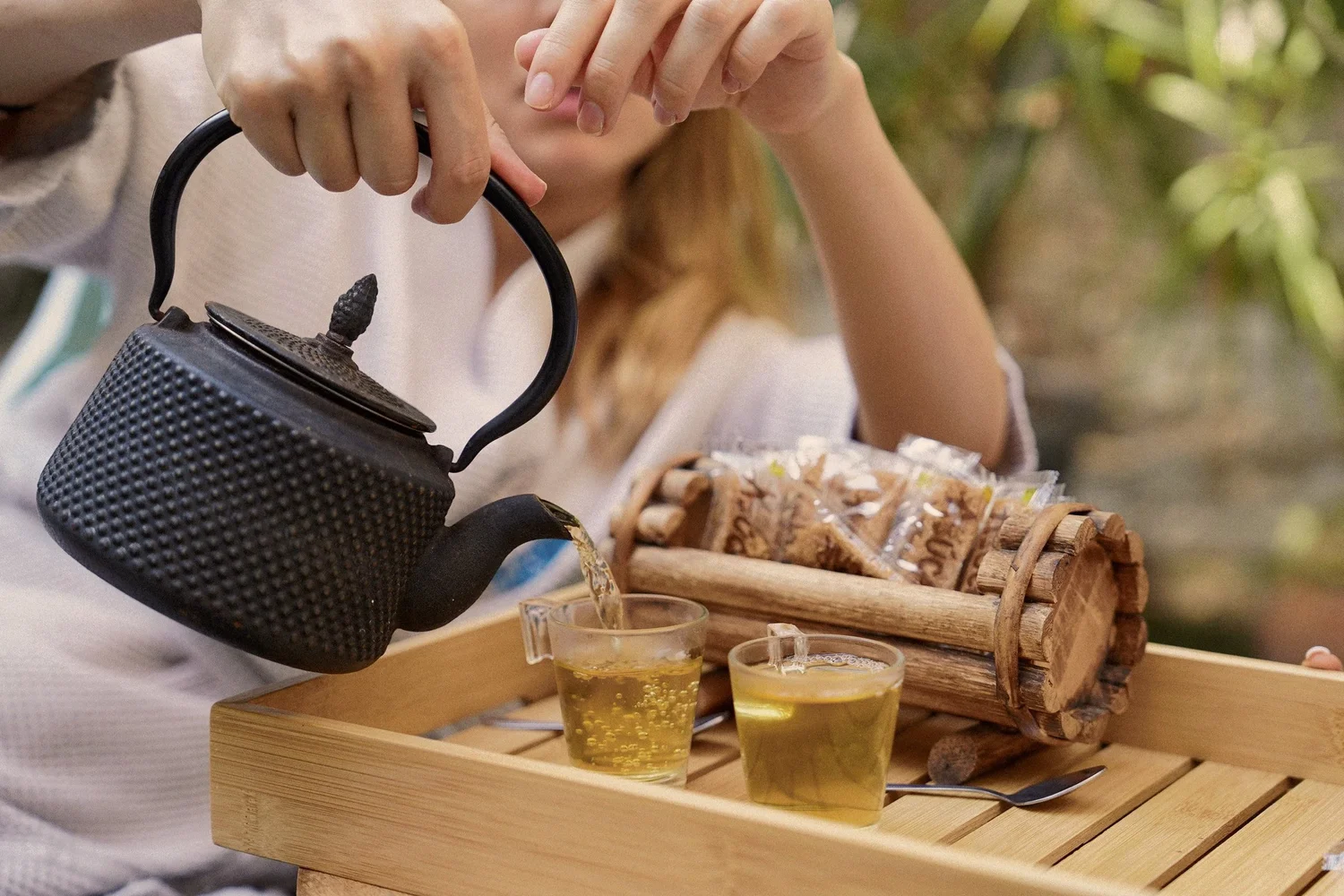 Mint tea being poured into tea glasses