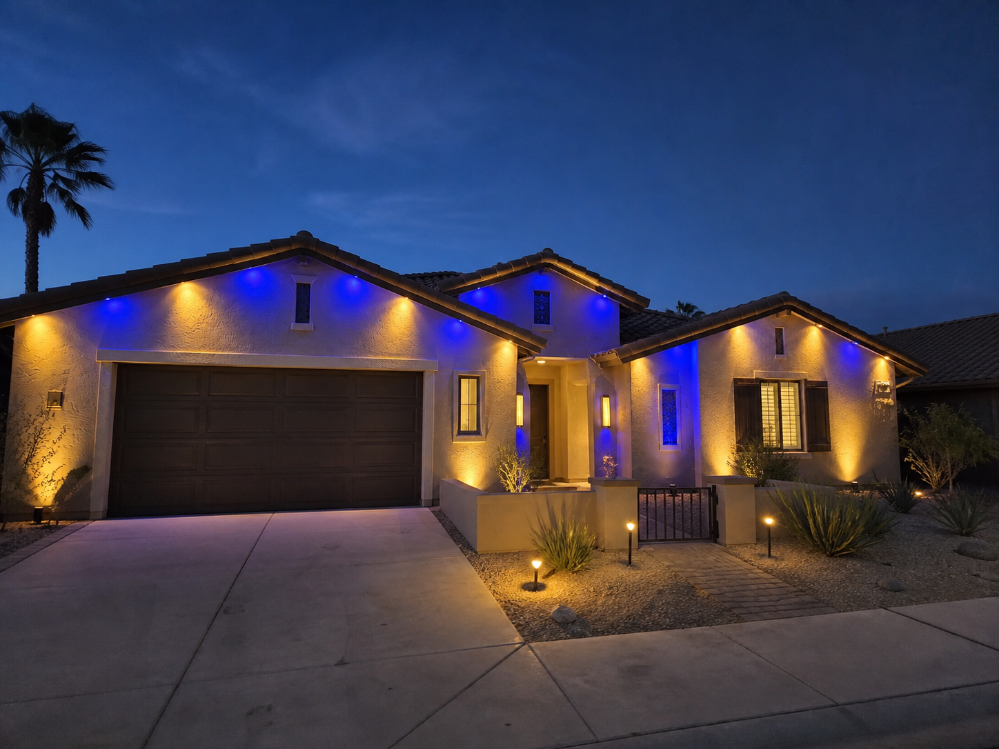 Concept example of blue and gold permanent outdoor lighting on a desert stucco home